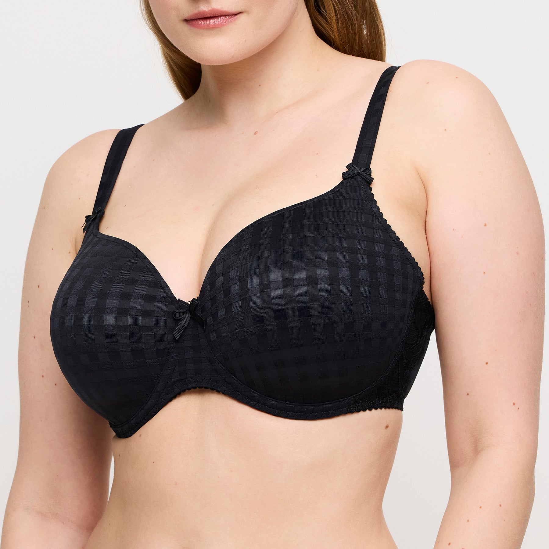 PrimaDonna Madison padded heart bra in black on model showing supportive underwire fit, deep neckline, and signature textured gingham fabric.