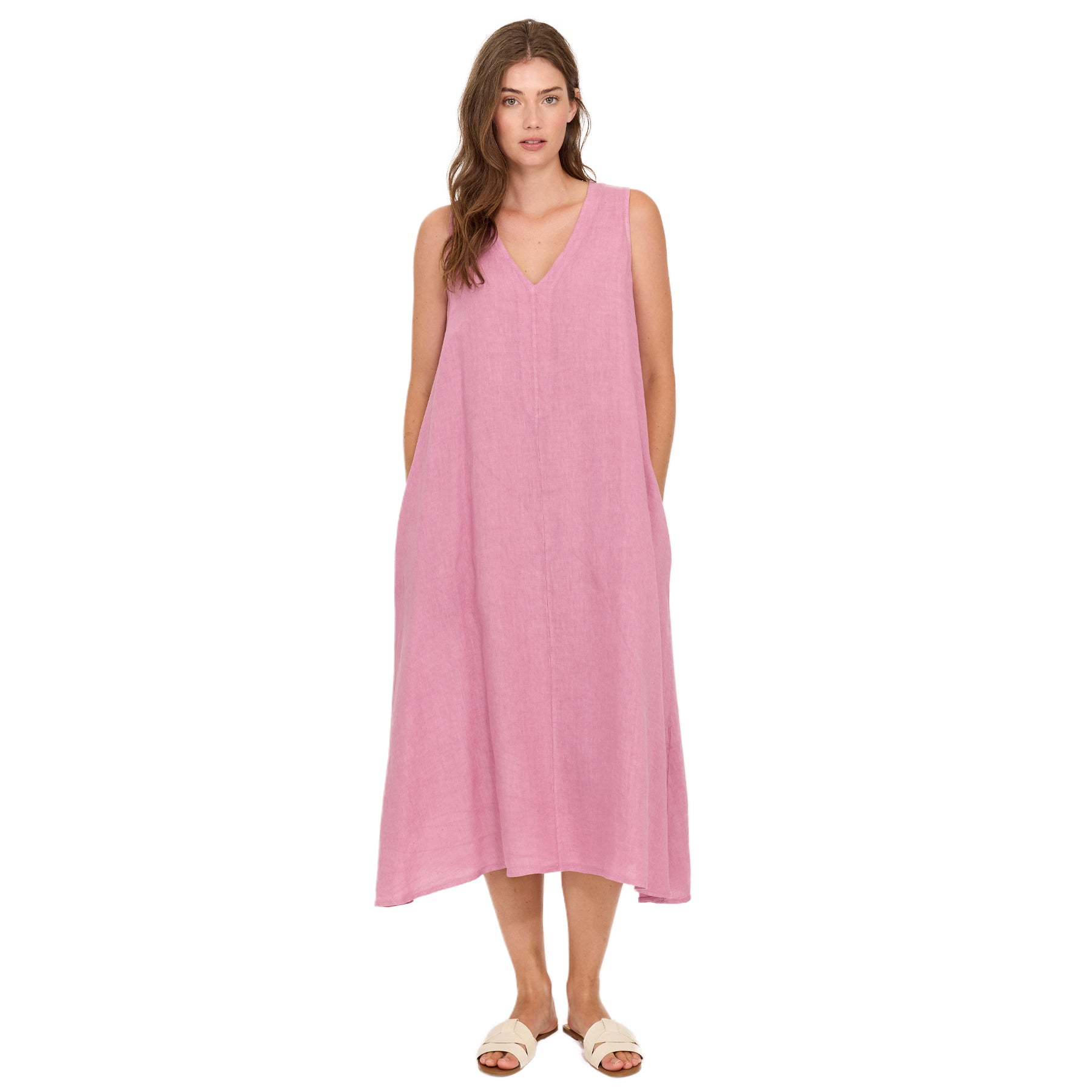 Woman wearing peony pink sleeveless linen midi dress with V-neckline and relaxed A-line silhouette