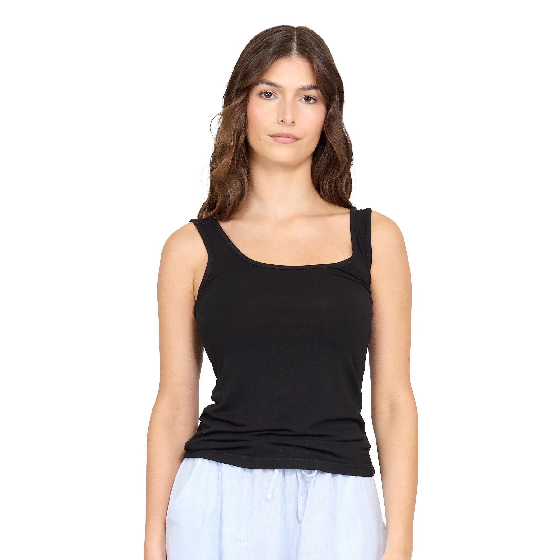 Woman wearing black viscose sleeveless tank top with scoop neckline and light blue lounge shorts.