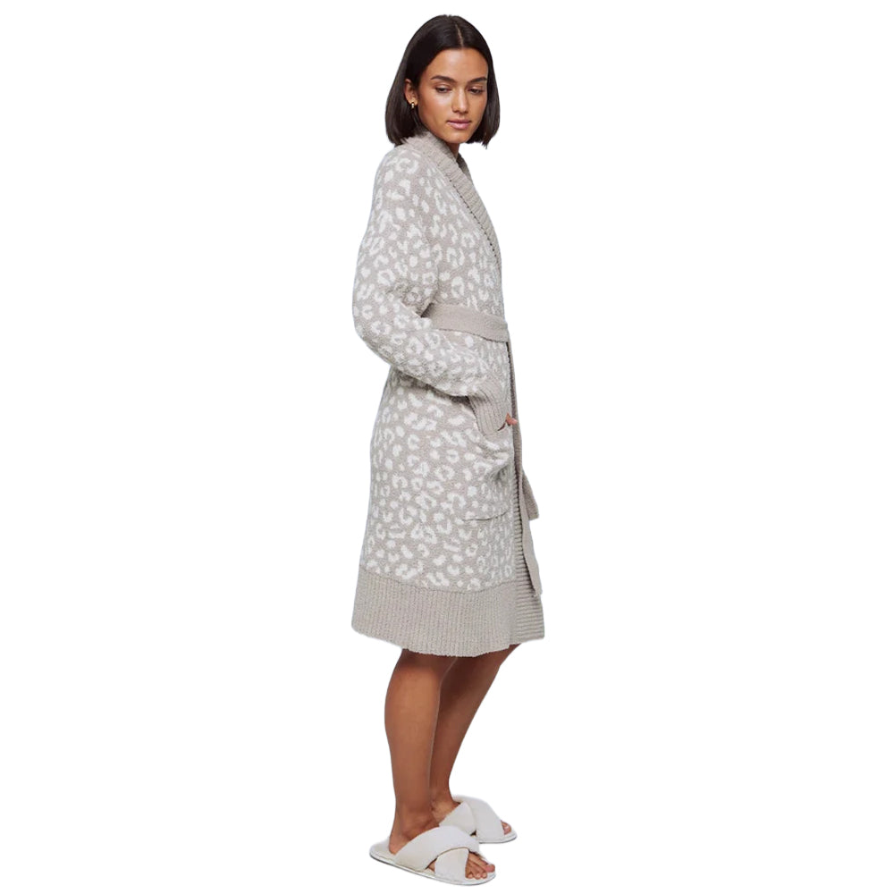 Side view of a model wearing a beige and ivory leopard-print wrap robe featuring a relaxed knee-length fit, long sleeves, waist tie, and front patch pockets.
