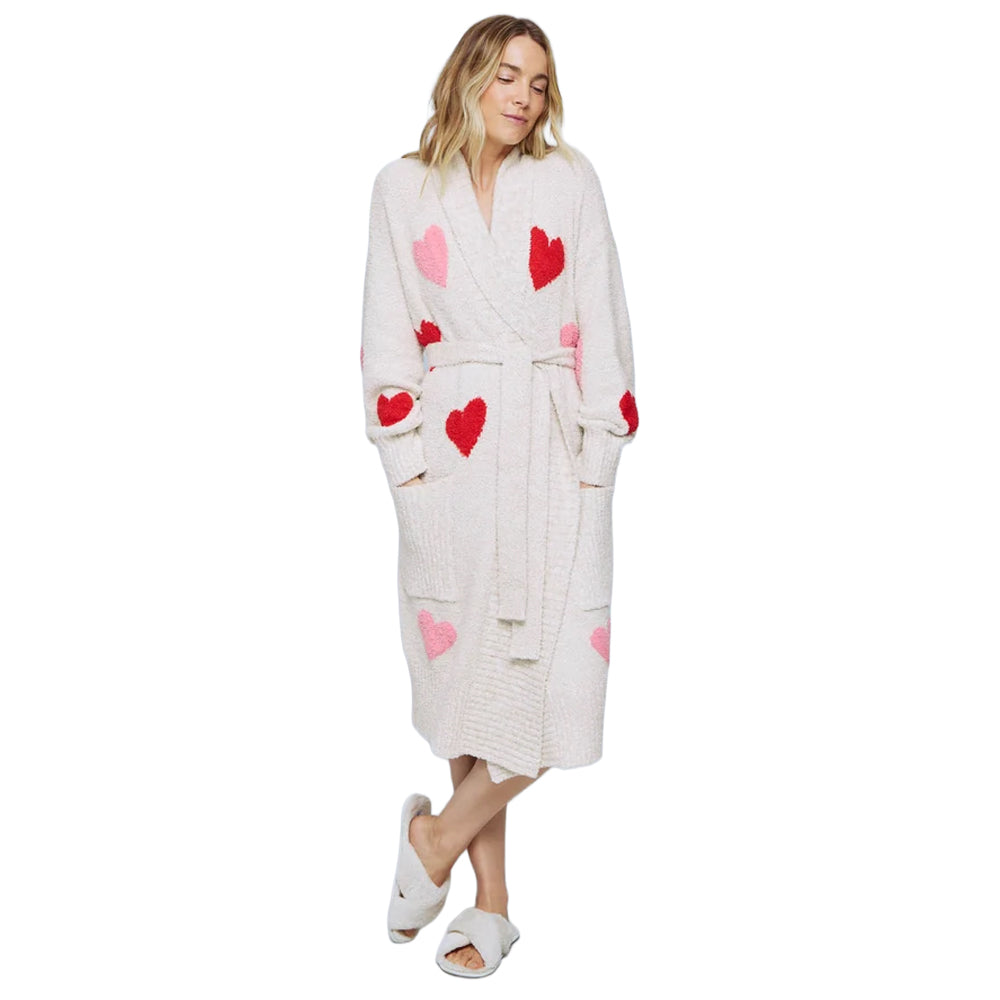 Model wearing a cozy oat heather wrap robe with red and pink heart patterns, shawl collar, matching waist tie, long sleeves, and front patch pockets.
