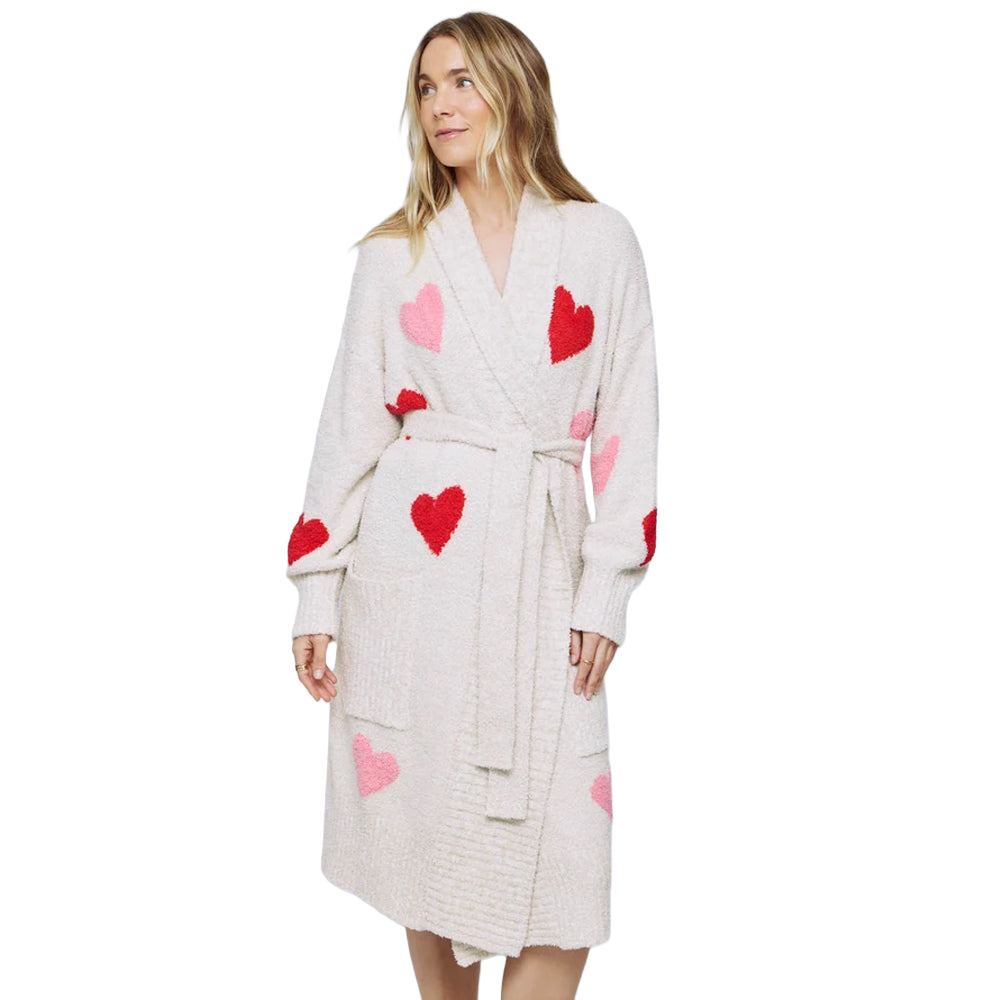 Model showcasing a plush oat heather heart-print robe with a wrap-front design, belted waist, shawl collar, and pink and red hearts.