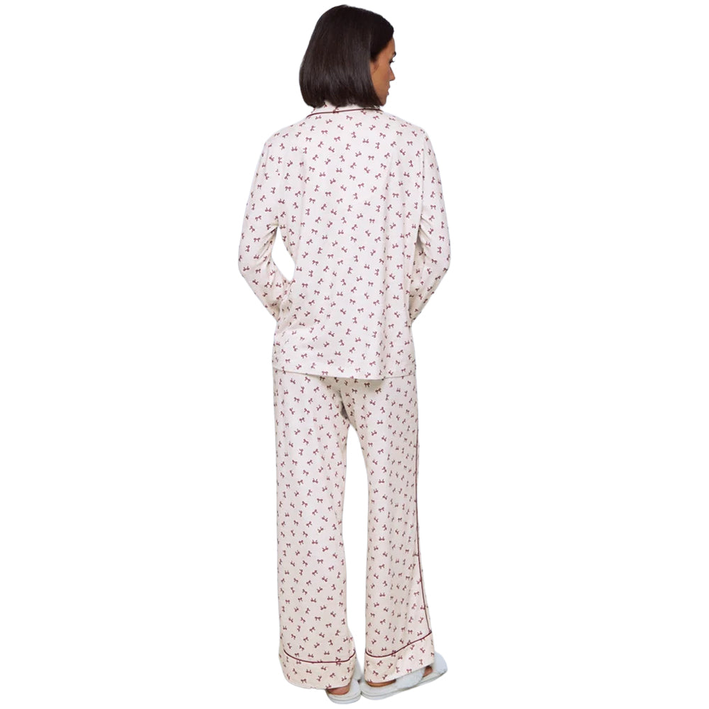 Splendid Pillowsoft PJ Set in White Bow Toss print, featuring a white long-sleeve pajama top and matching wide-leg pants with burgundy bow pattern.