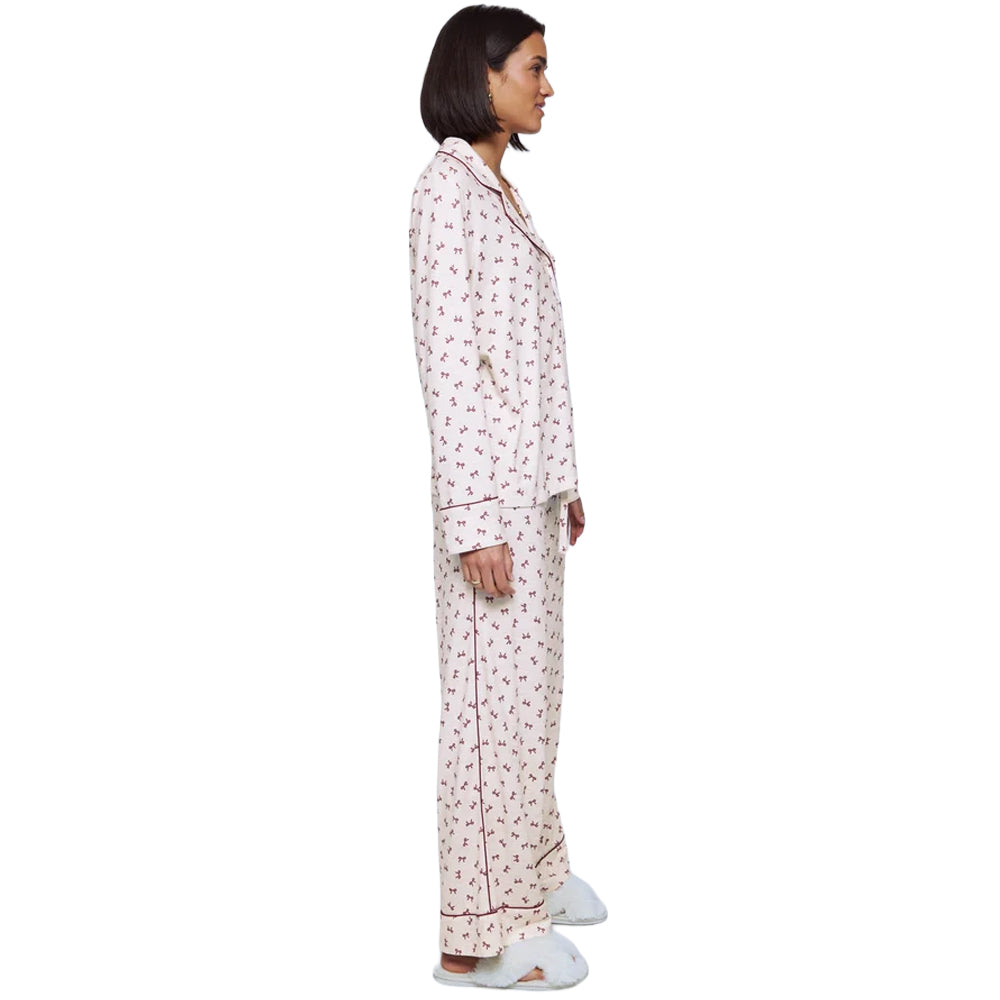 Side view of Splendid Pillowsoft women's white bow print pajama set featuring a relaxed long-sleeve top and matching full-length pants.