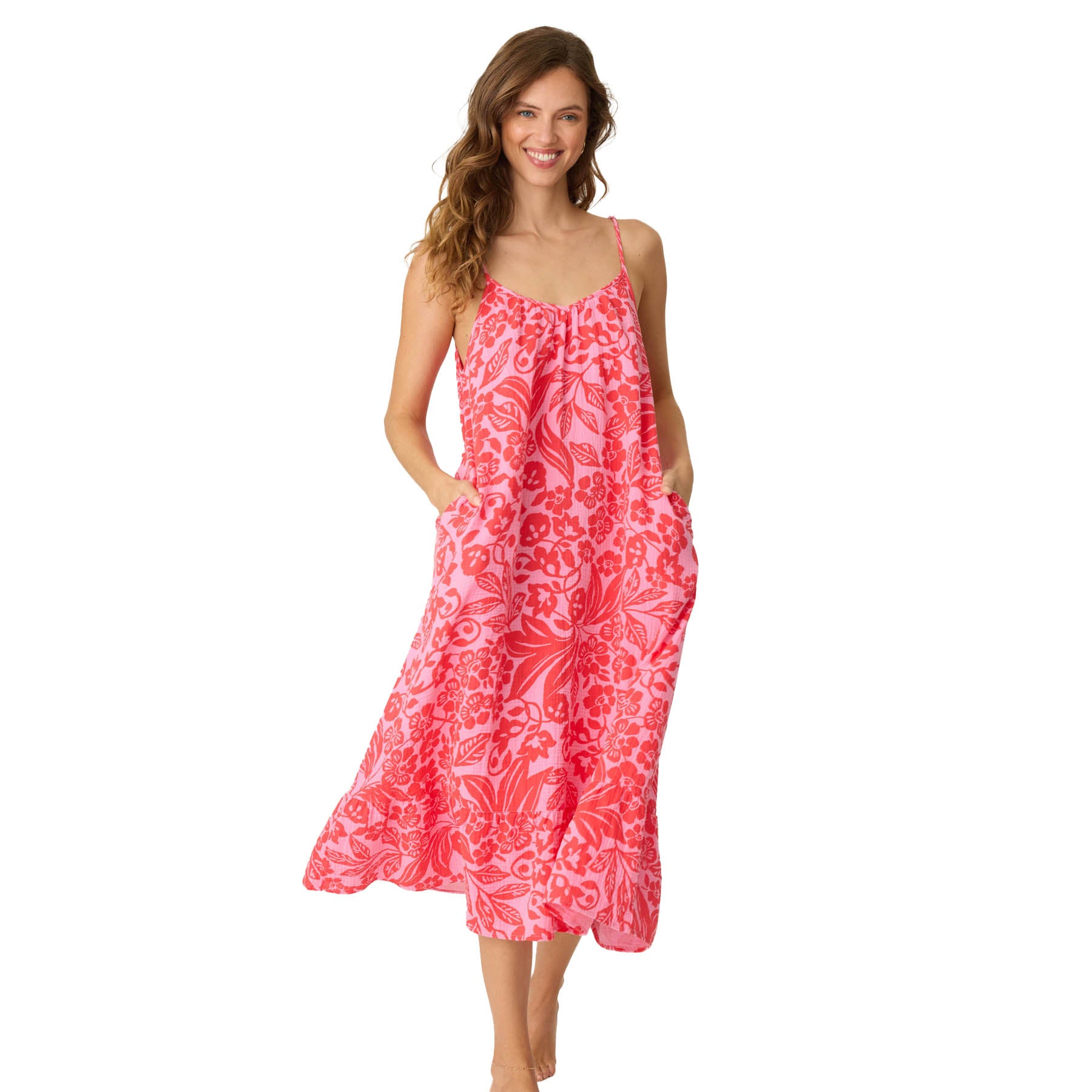 Woman wearing pink and red floral print midi dress with pockets and thin straps