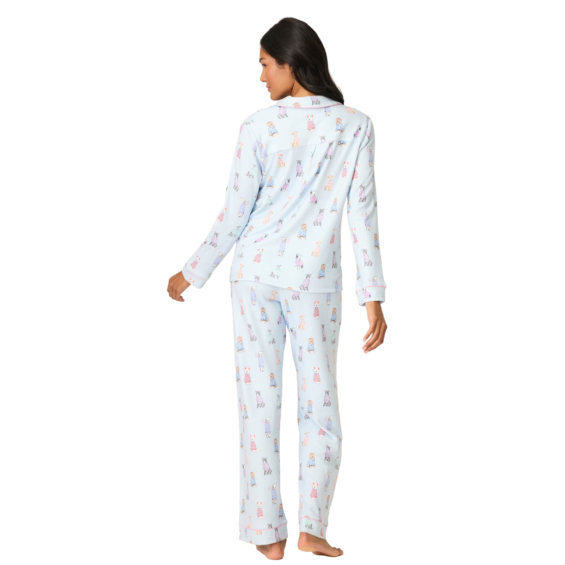 Woman wearing a light blue pajama set with animal print on a white background