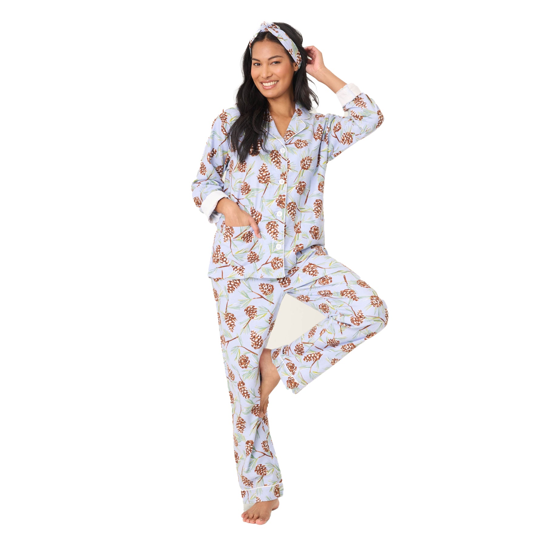 Woman wearing a floral pajama set on a white background