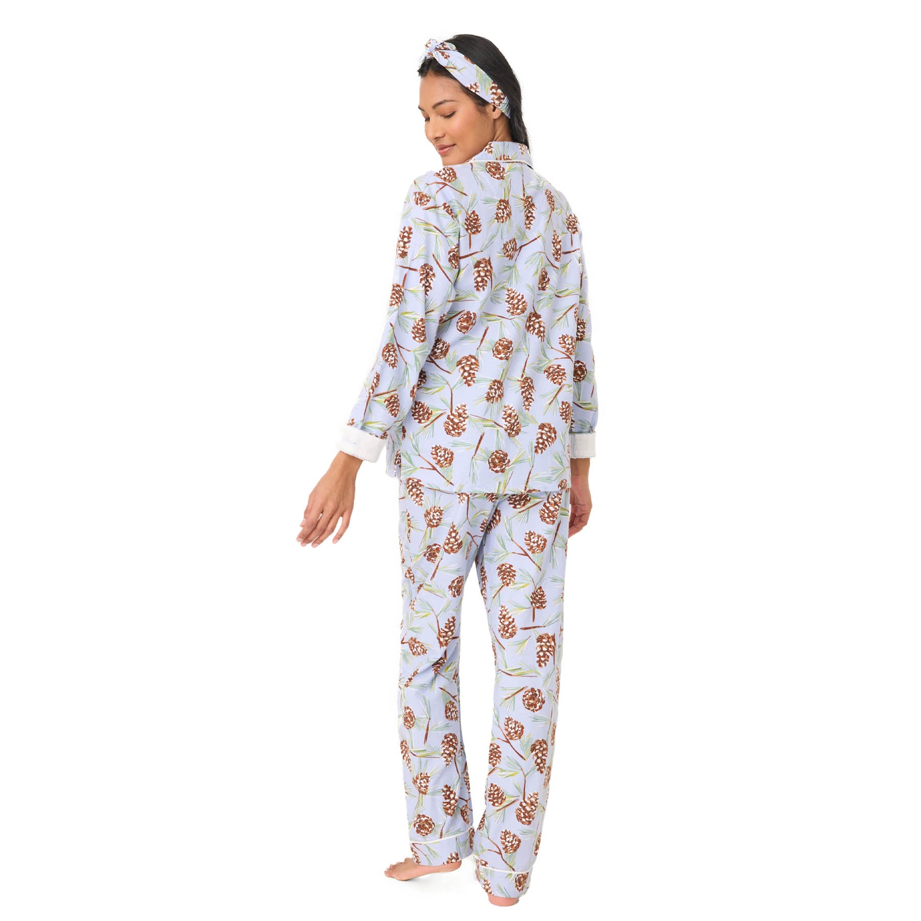 Woman wearing a floral pajama set on a white background