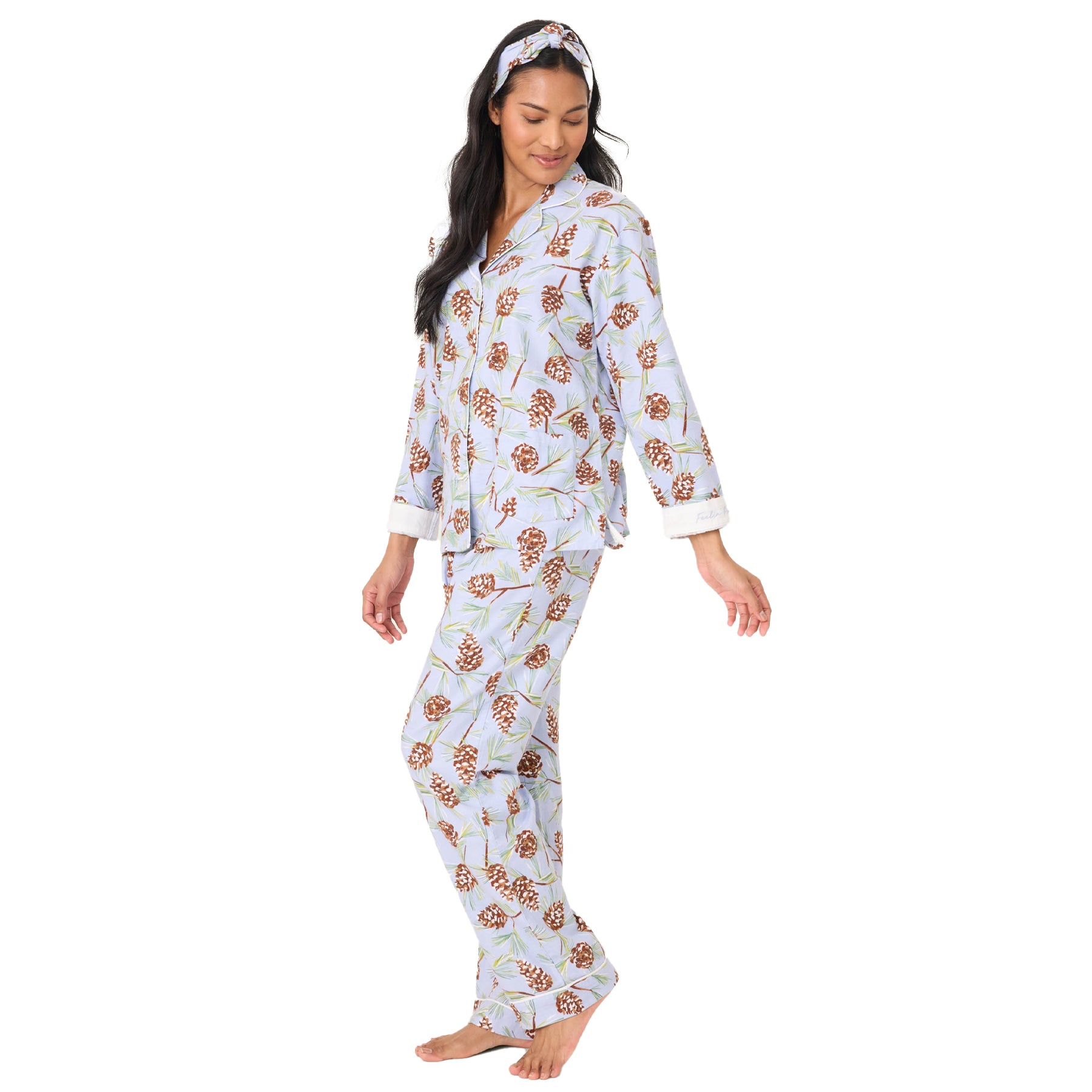 Woman wearing a floral pajama set on a white background