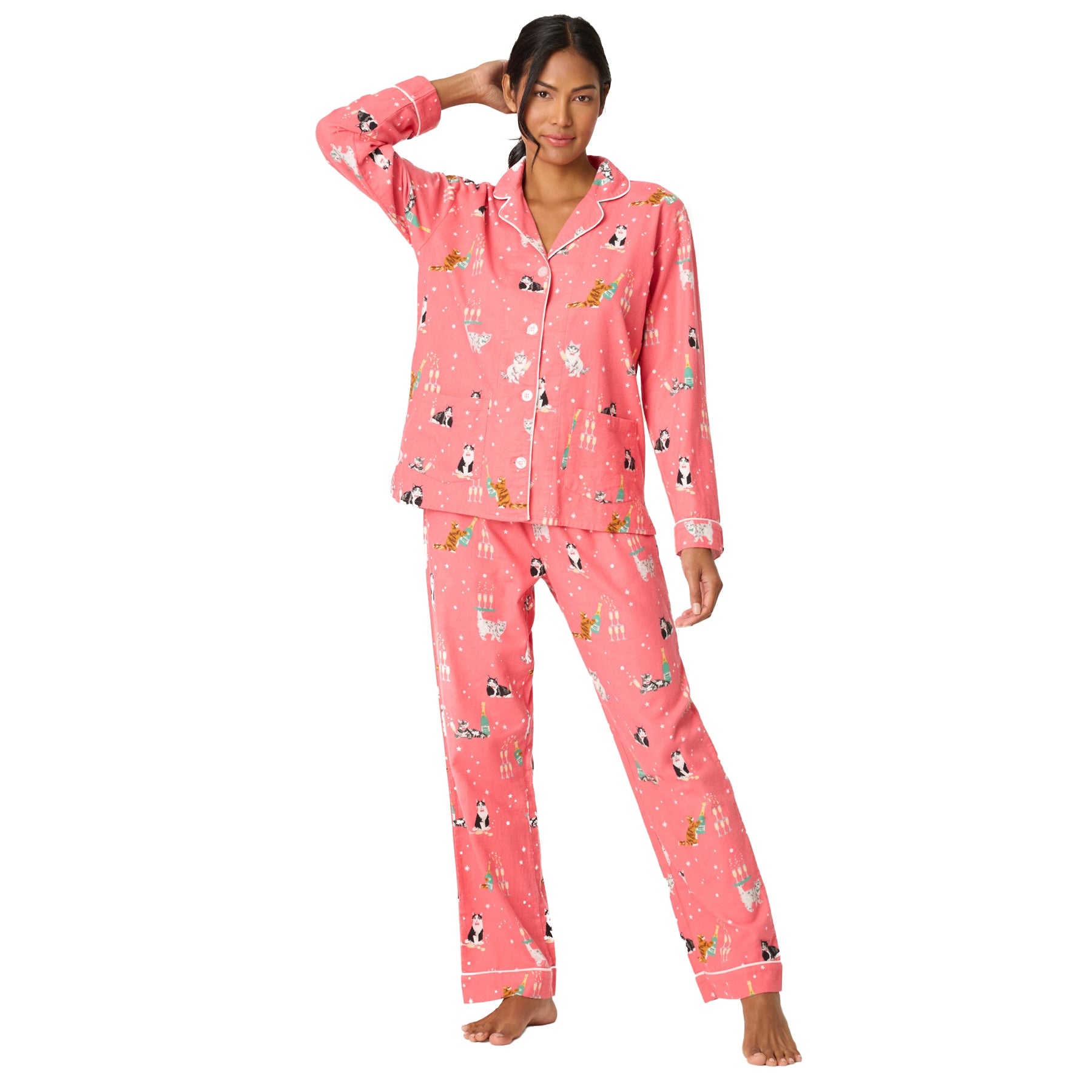 Woman wearing pink pajamas with animal print on a white background