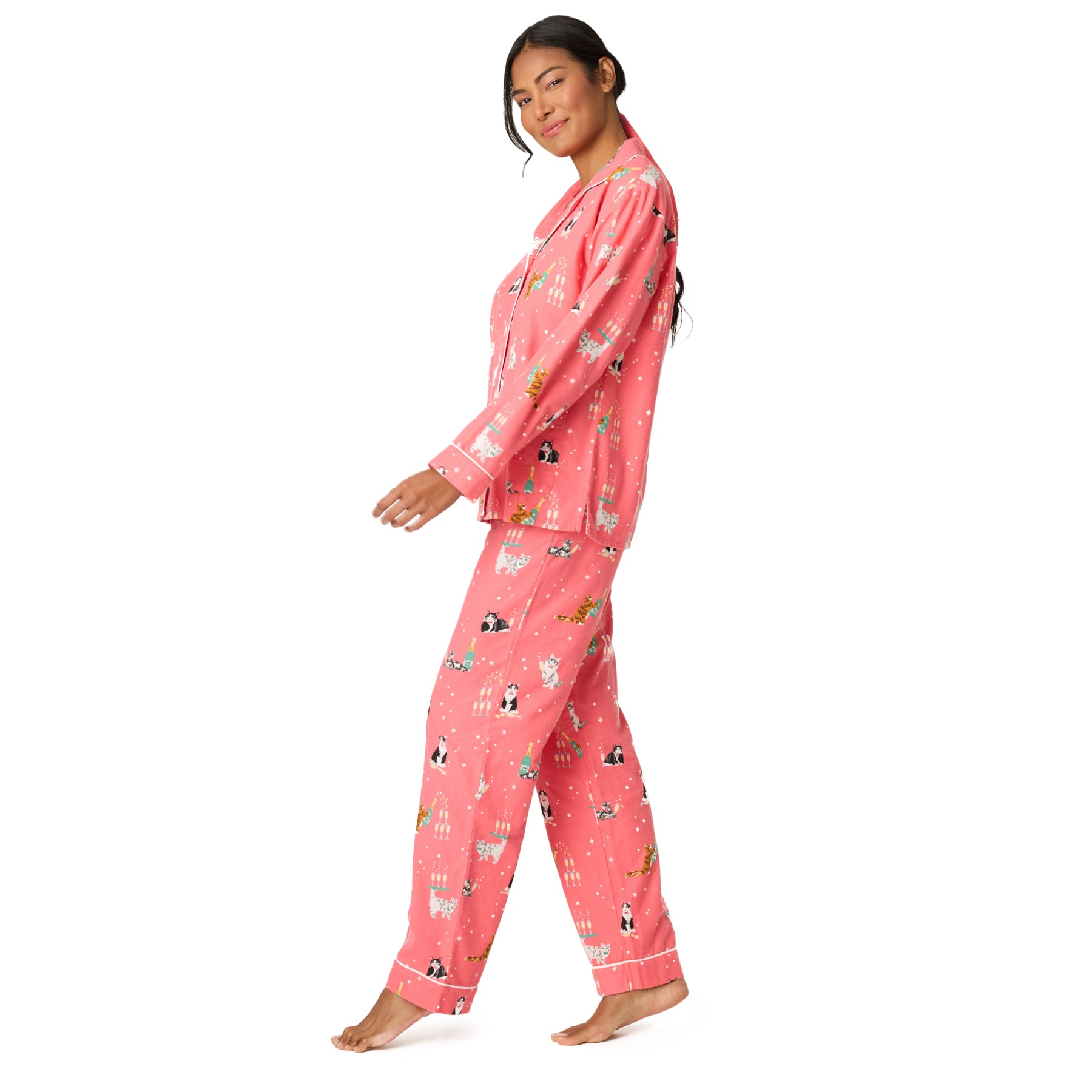 Woman wearing pink pajamas with animal print on a white background