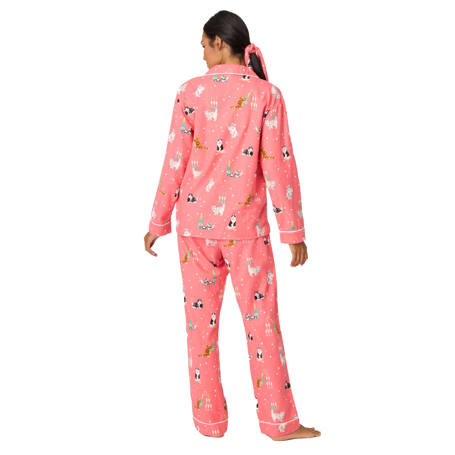 Person wearing pink pajamas with animal print on a white background