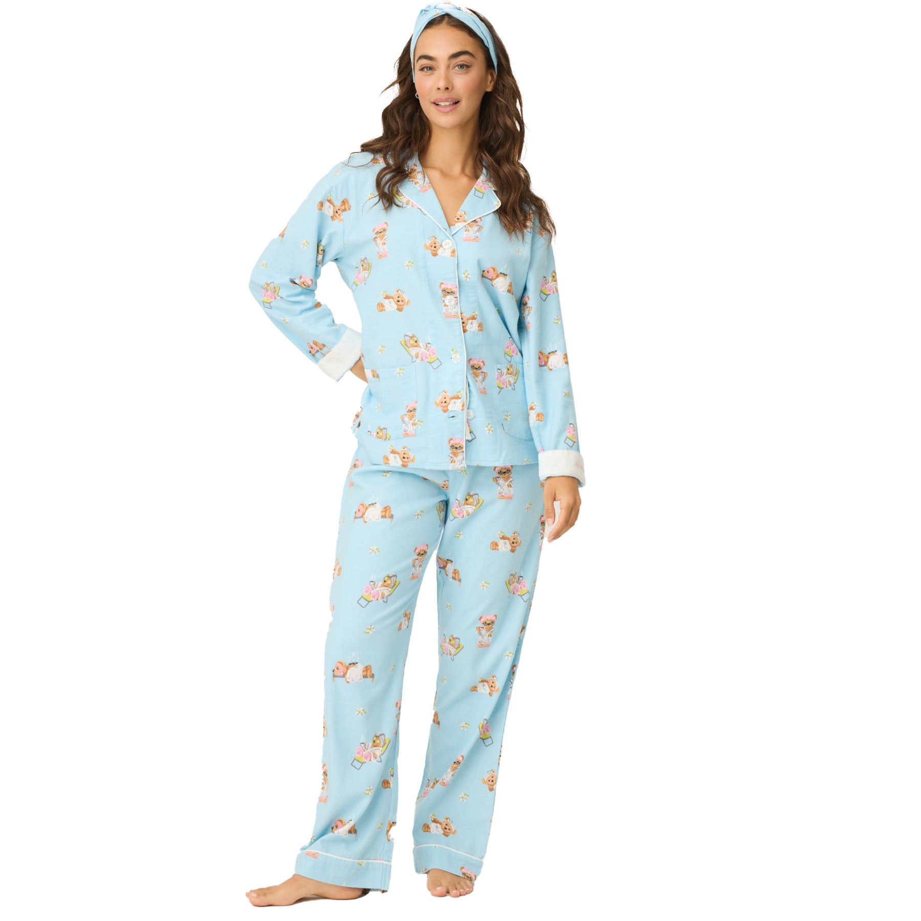 Woman wearing light blue pajama set with playful spa bear print and matching headband.