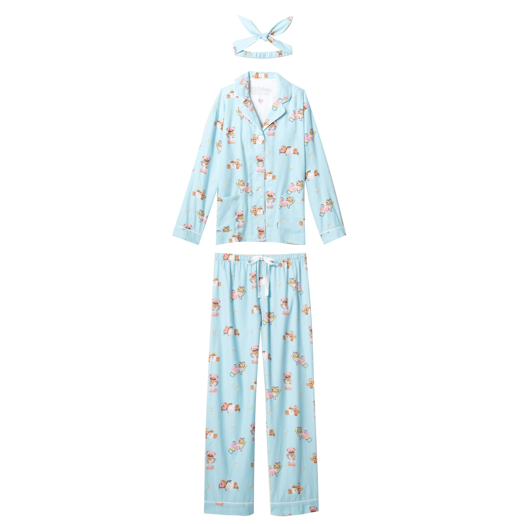 Flat lay of blue pajama set with bear print, button-front top, pants, and headband.