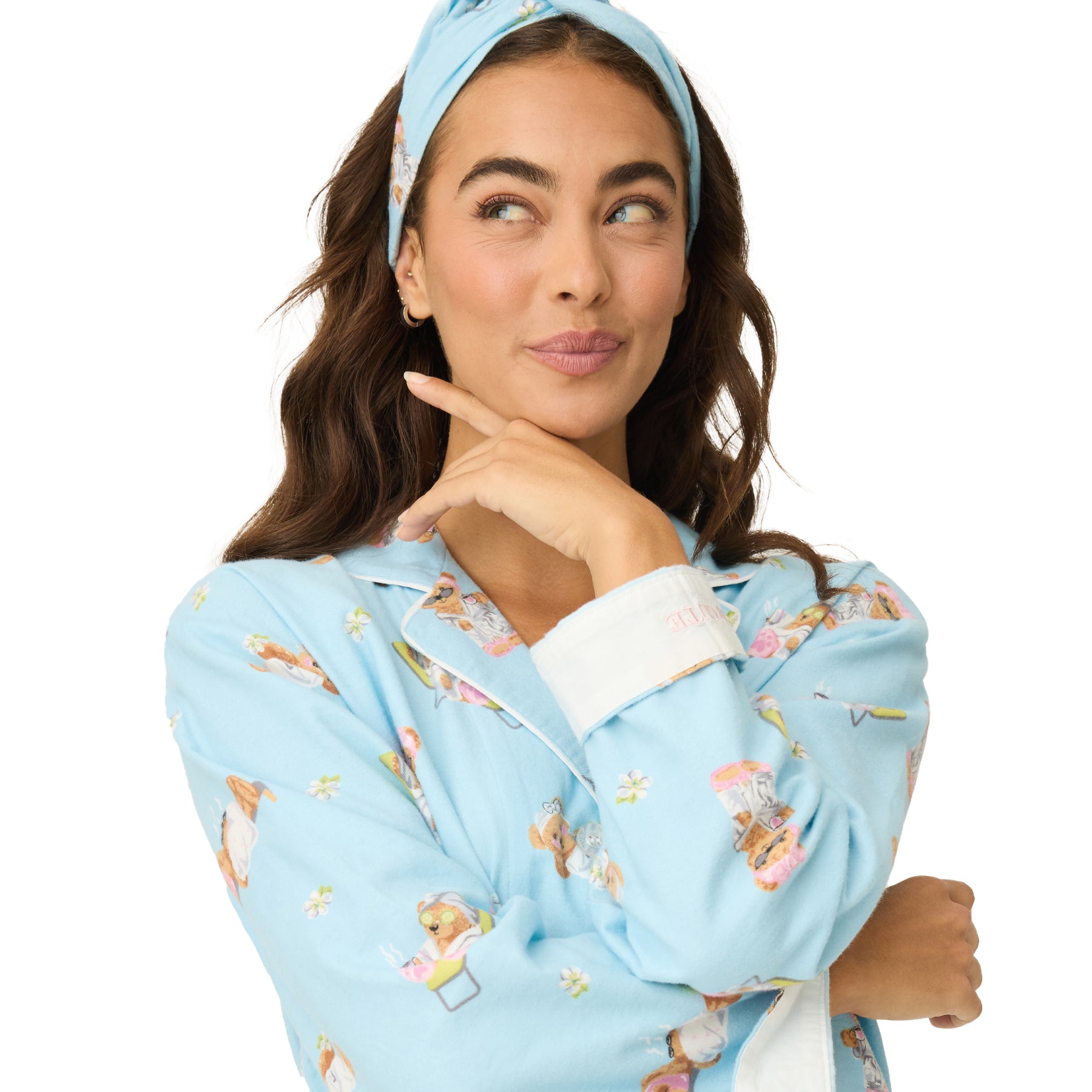 Close-up of woman in blue pajama set with spa bear pattern and matching headband.