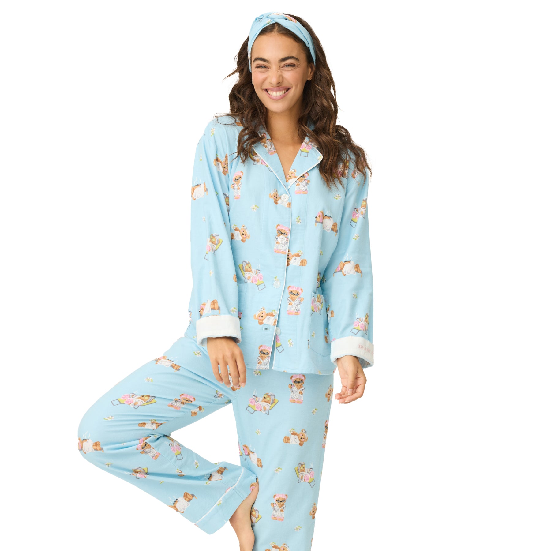 Woman smiling in light blue “Beary Cute” pajama set with bear spa design.