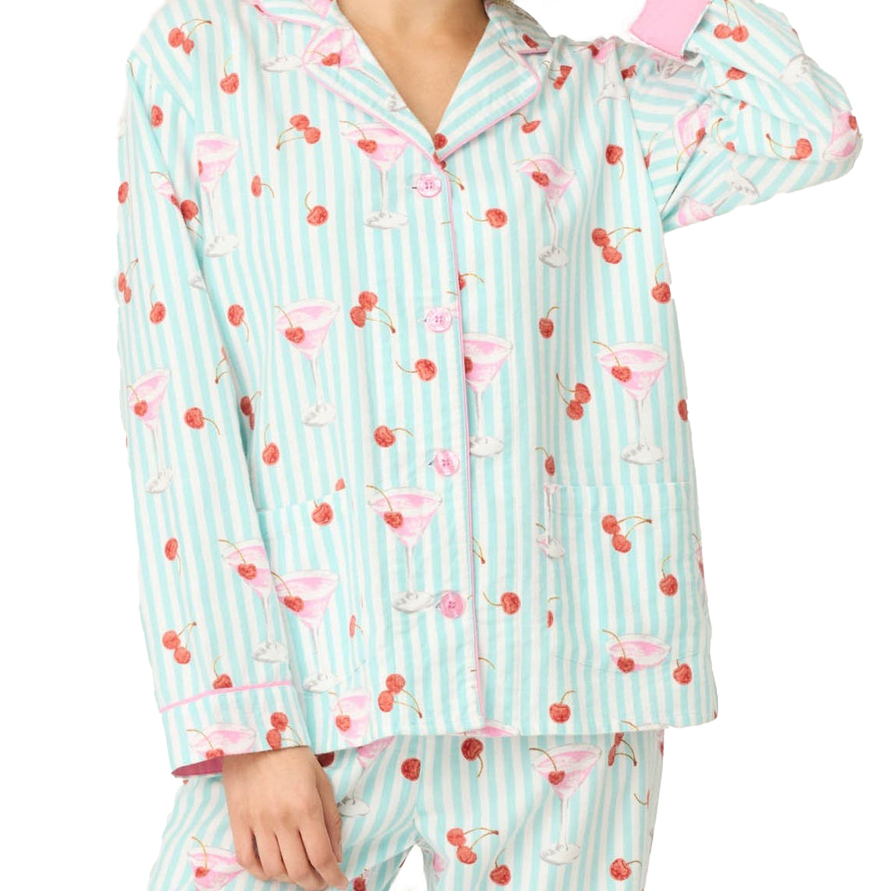 Close-up of mint green striped pyjama top with pink martini glass and cherry print and pink button details.