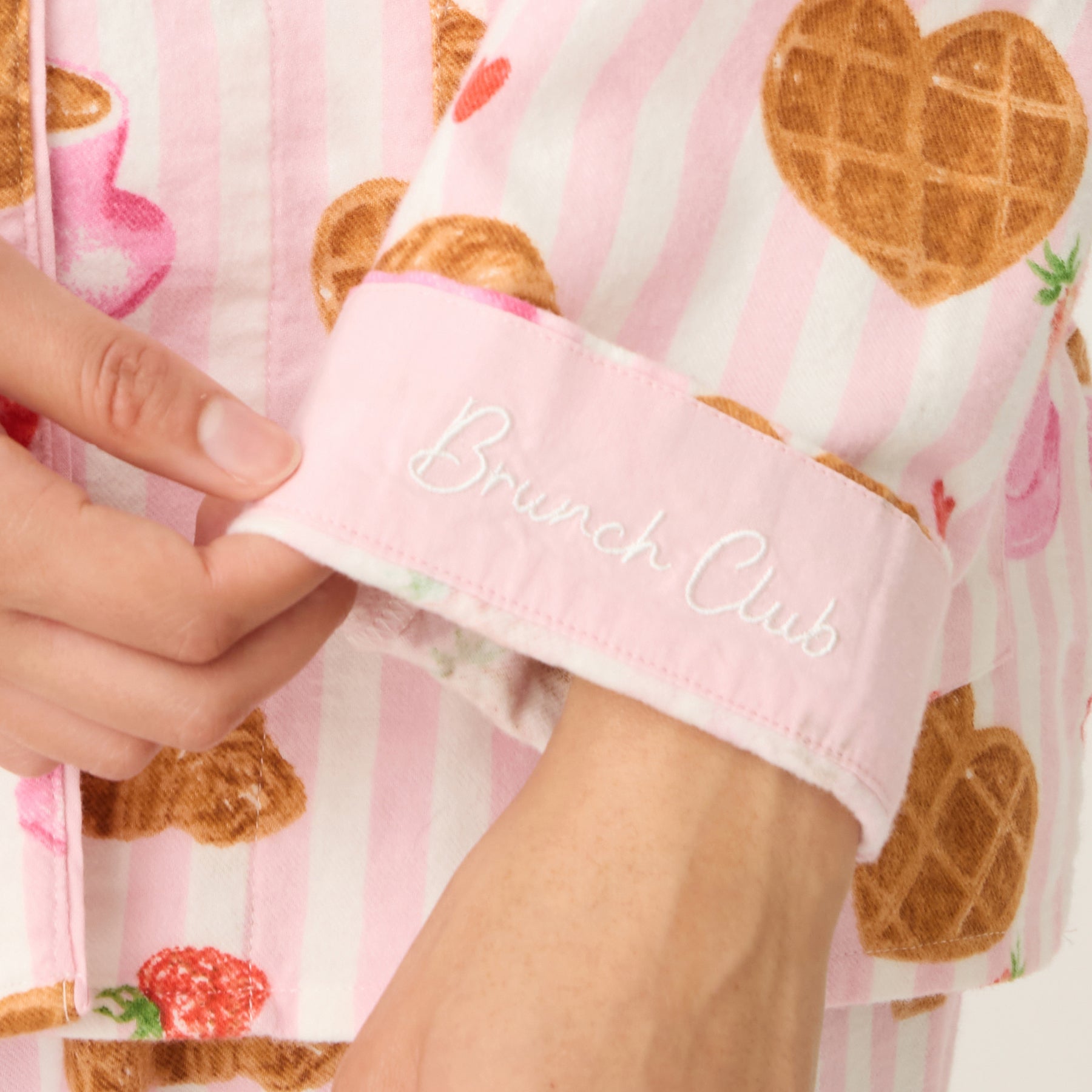 Sleeve cuff detail with “Brunch Club” embroidery on pajama top.