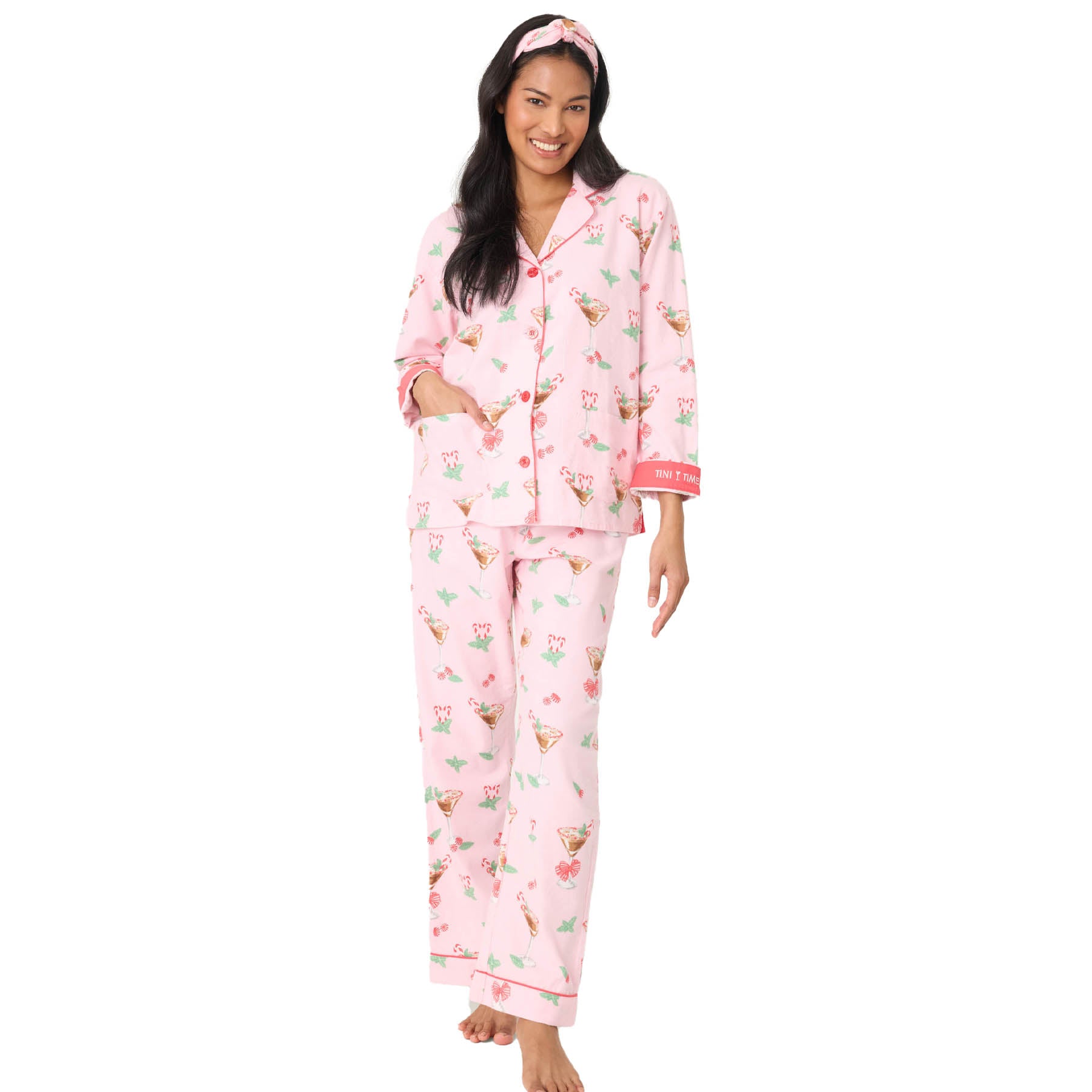 Woman wearing pink pajamas with a floral pattern on a white background