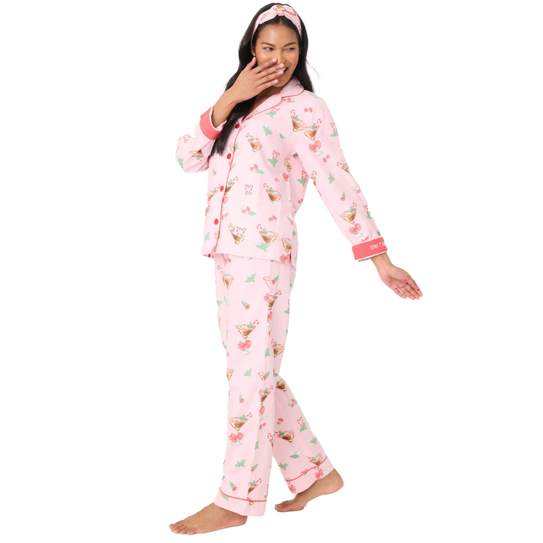 Woman wearing pink pajamas with a floral pattern on a white background