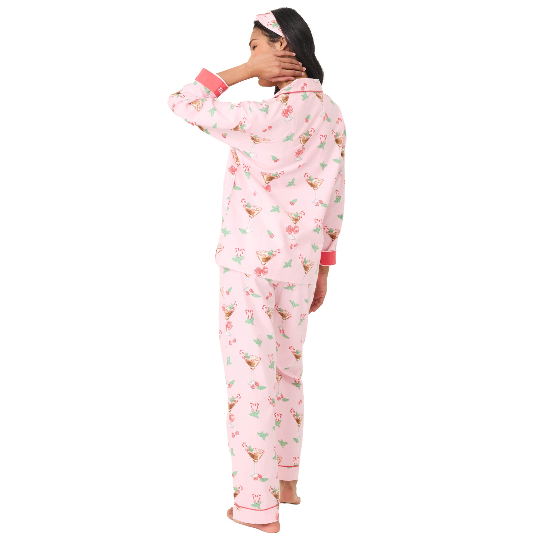 Woman wearing a pink floral pajama set on a white background