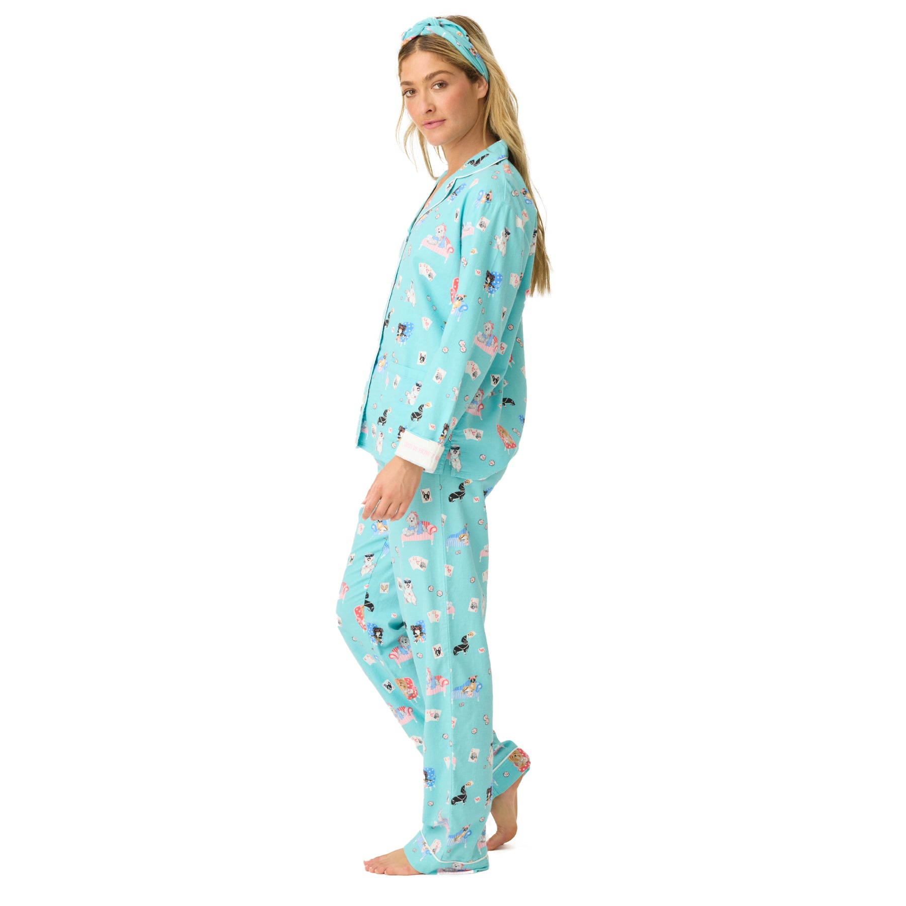 Side view of turquoise dog-print pajama set with matching headband.