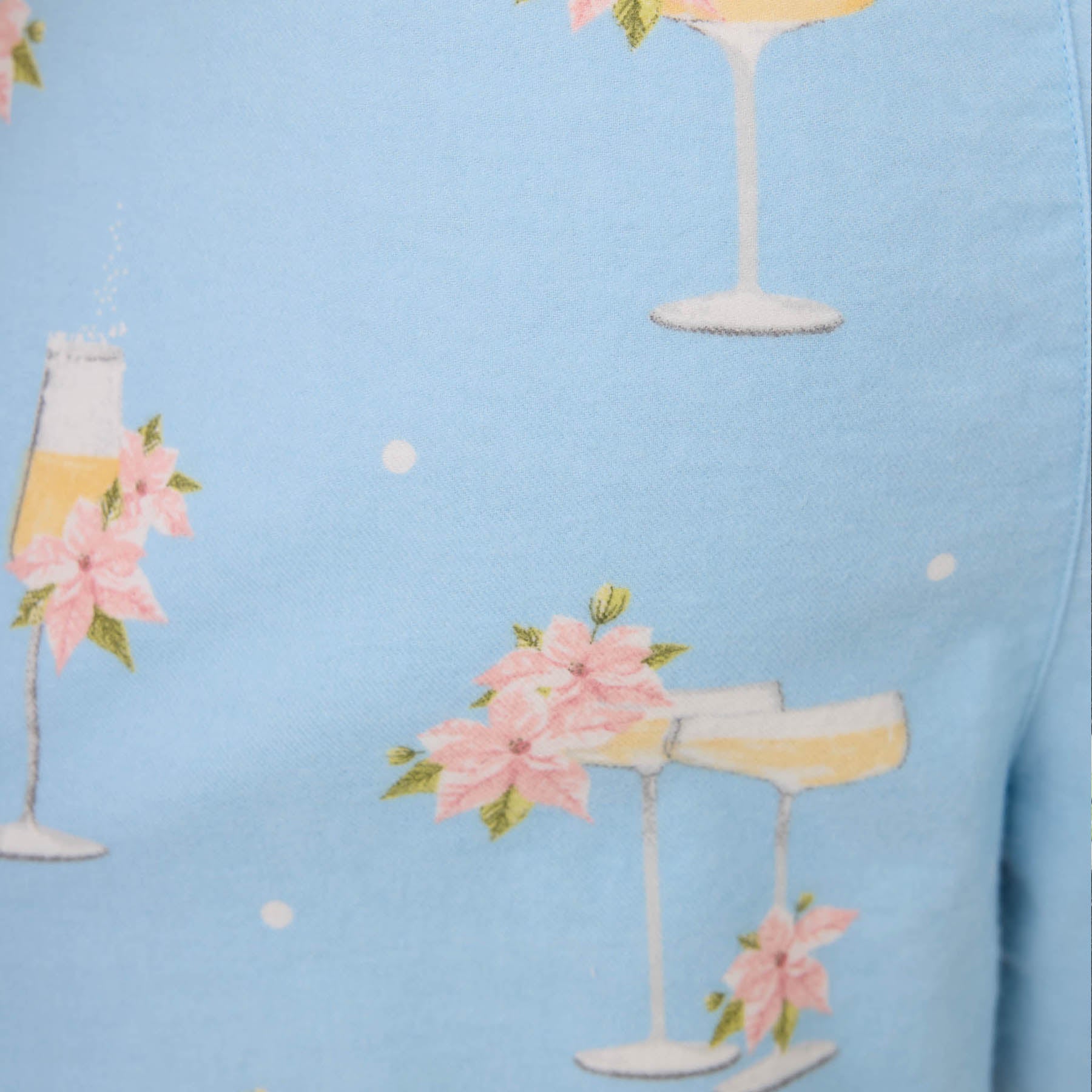 Pattern of champagne glasses with pink flowers on a light blue background