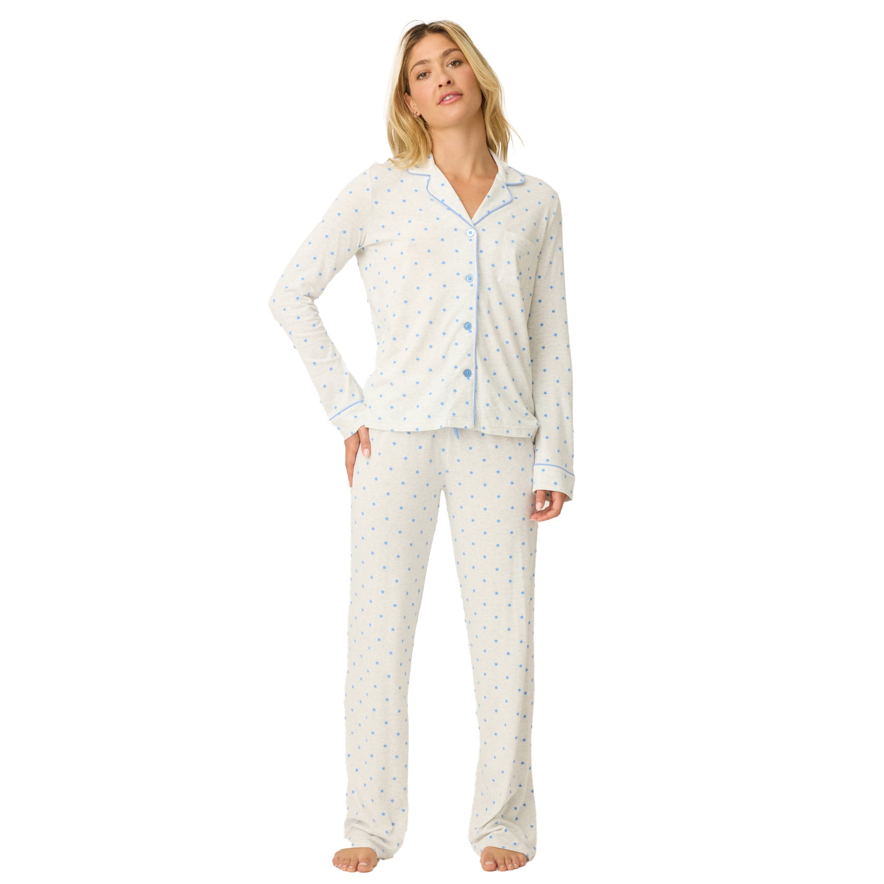 Woman wearing a light-colored pajama set with a subtle pattern on a white background