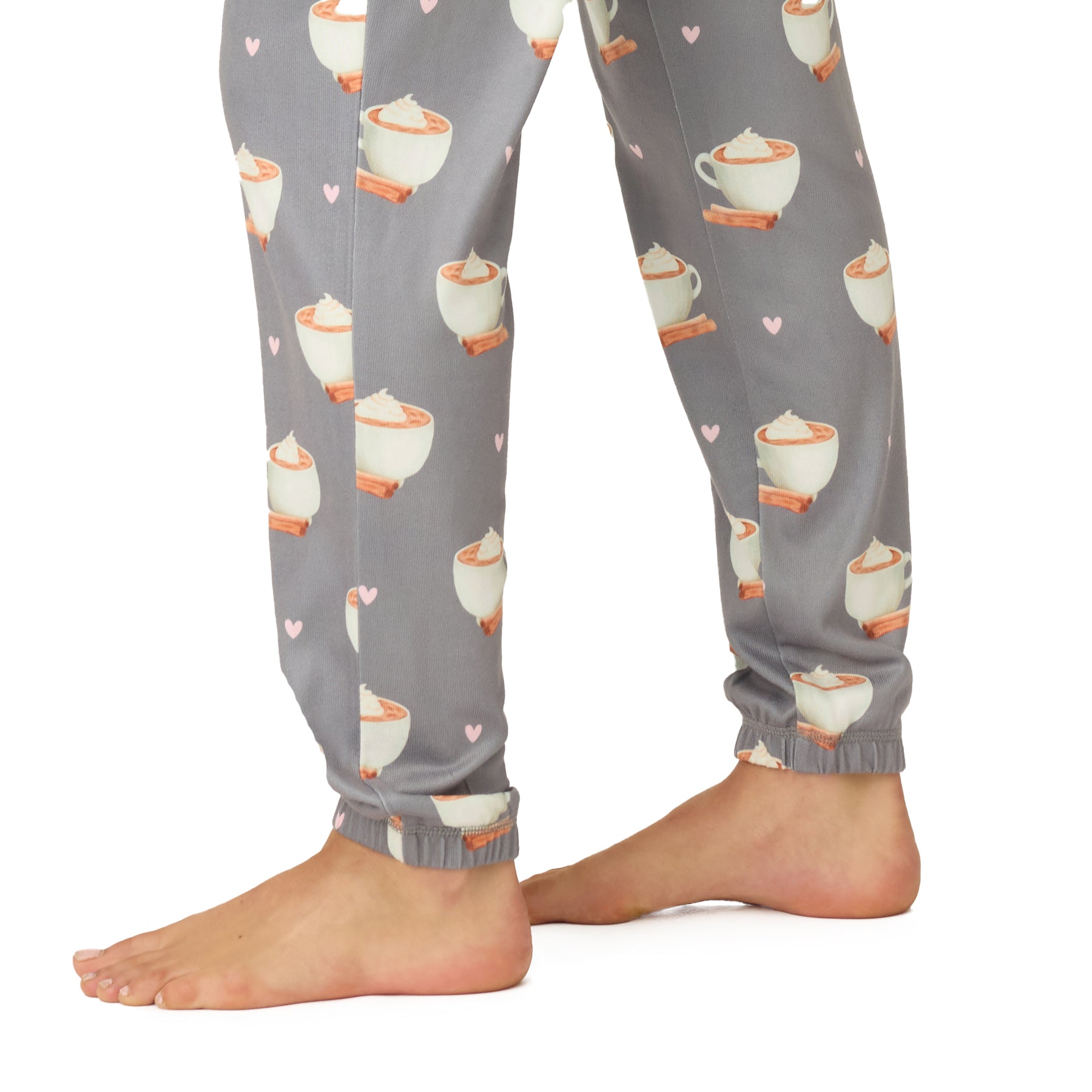 Close-up of pajama pants hem with cocoa mug pattern.