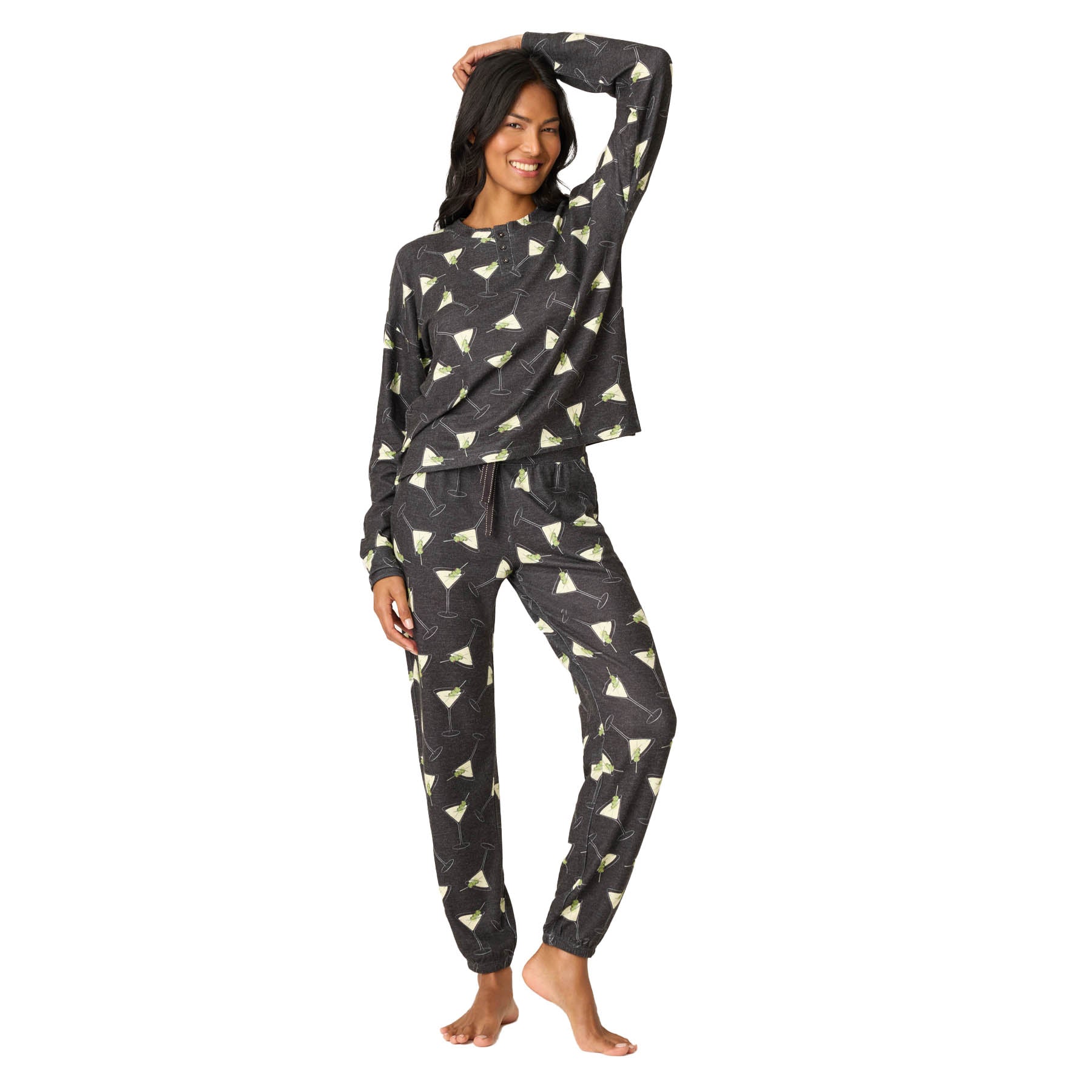 Woman wearing a black and white patterned pajama set on a white background