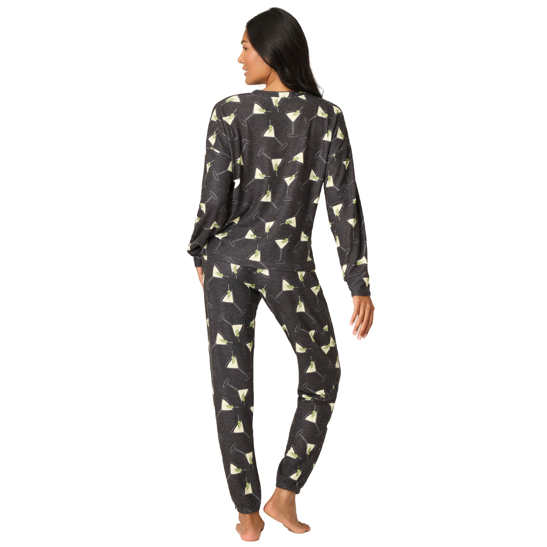 Woman wearing a black and white patterned pajama set on a white background
