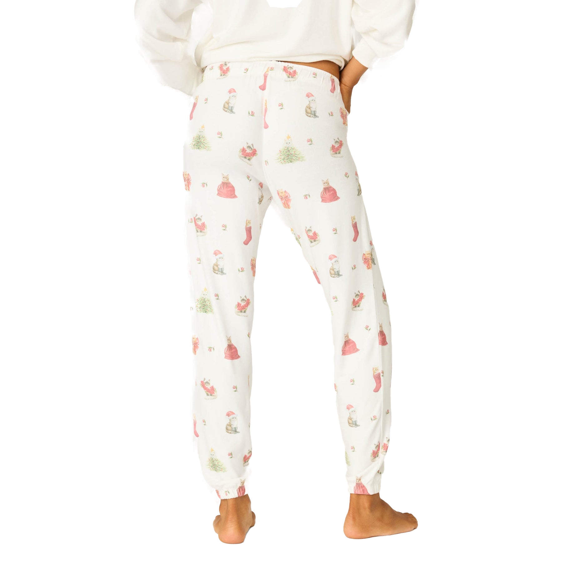 Person wearing a white sweatshirt and patterned pants on a white background