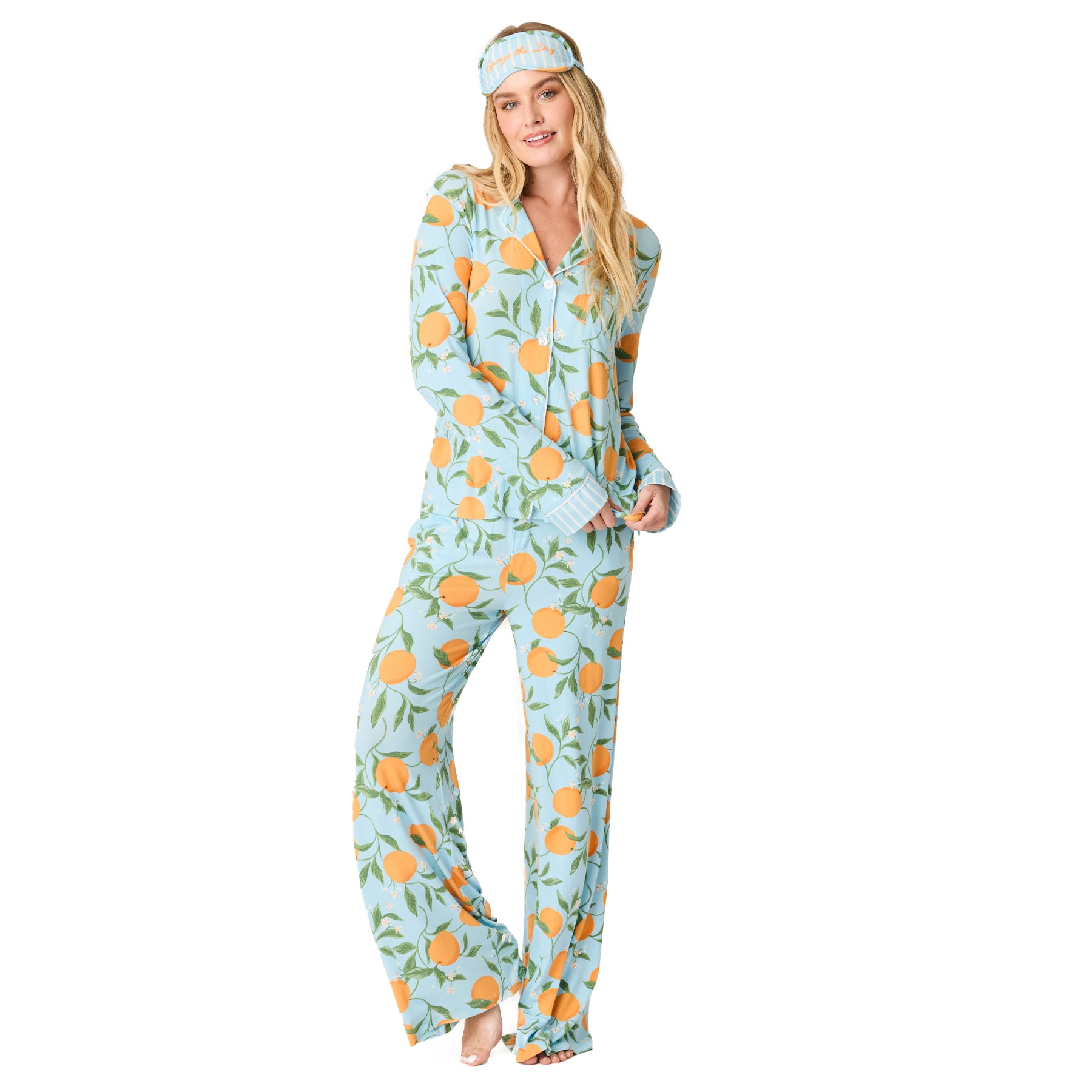 Women’s citrus print pyjama set in soft blue with orange and green motif, styled with coordinating sleep mask – front view