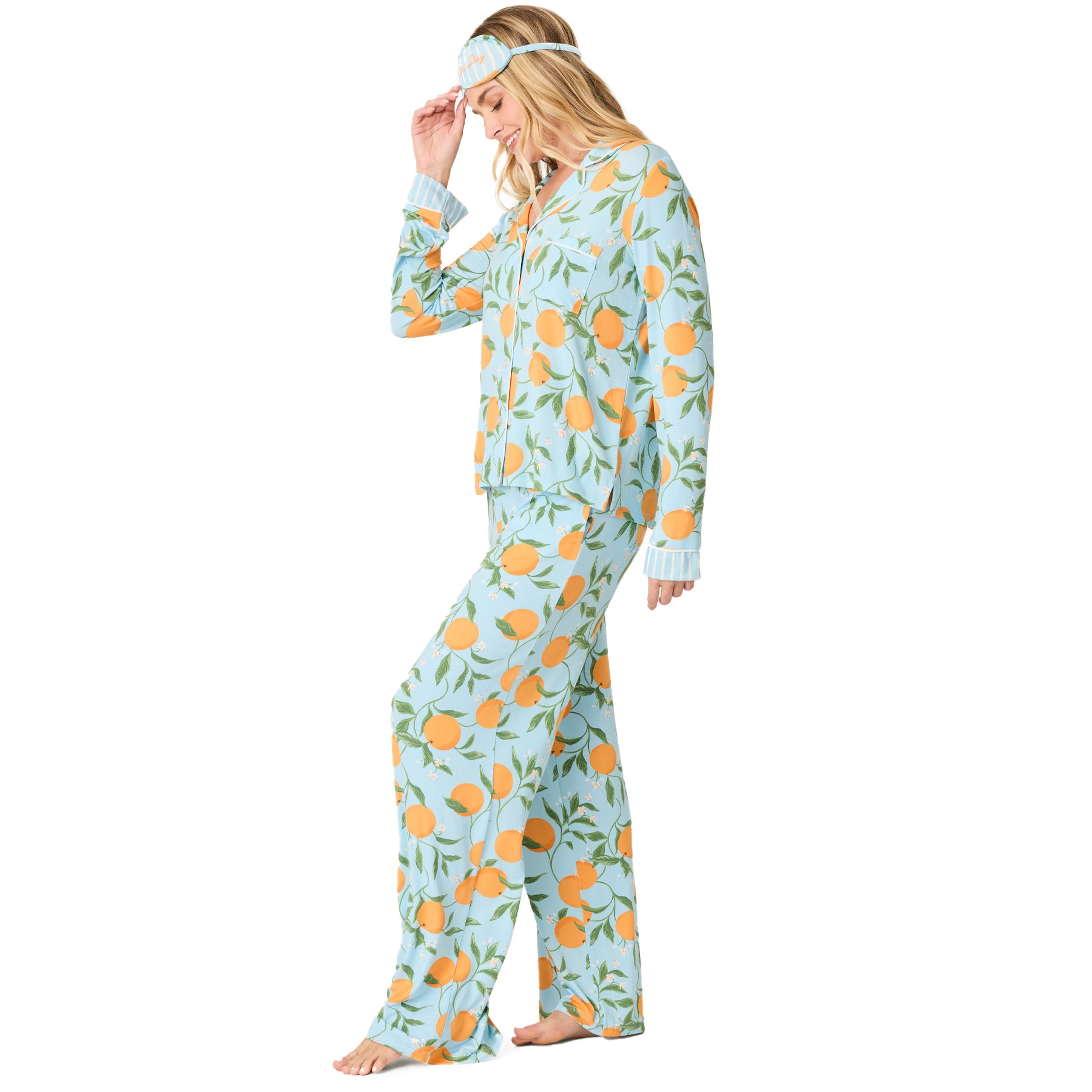 Side view of light blue citrus print pyjama set with relaxed fit long sleeve top and flowing wide-leg pants