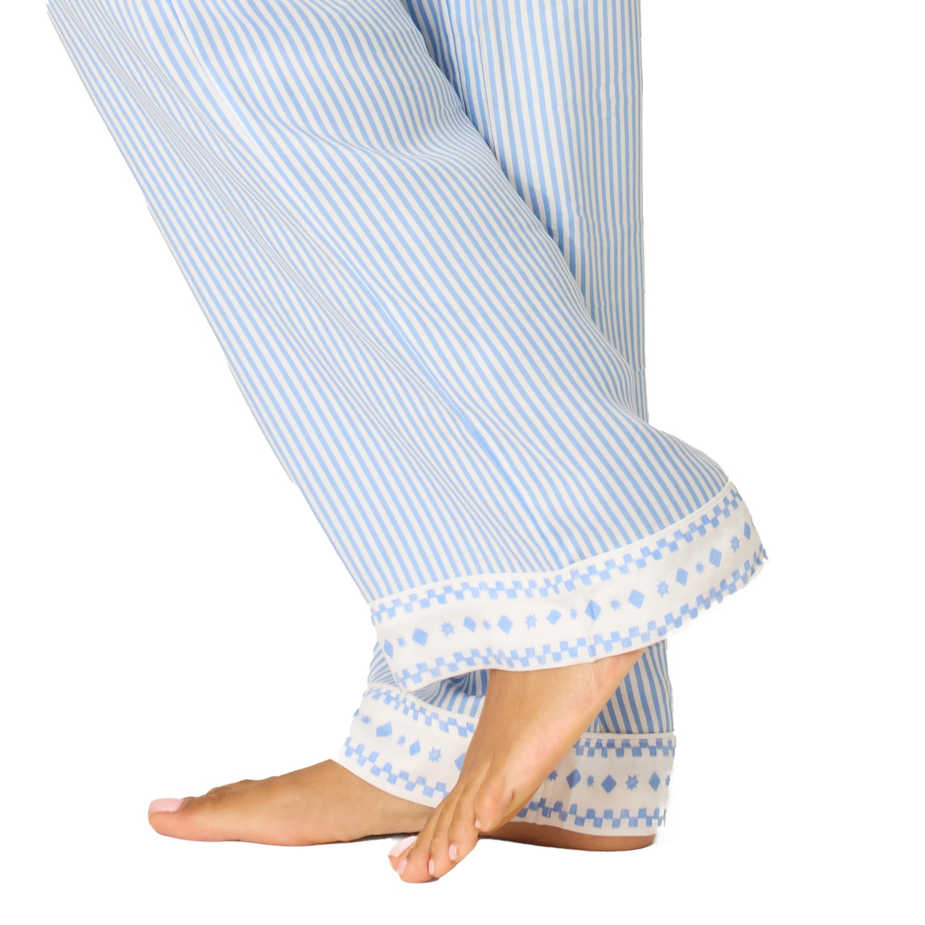 Detail of blue and white striped pyjama pants hem with decorative border print