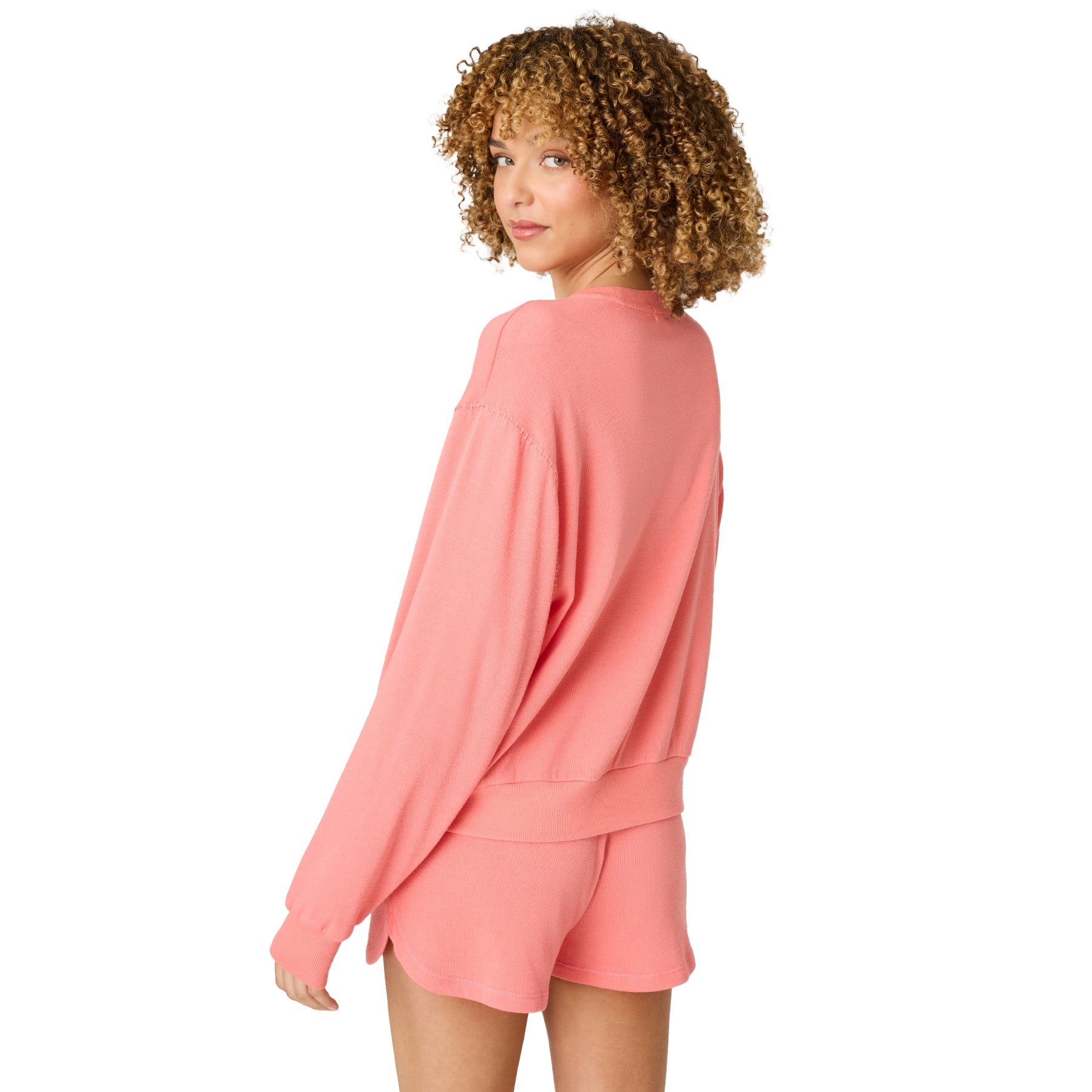 Back view of women’s coral lounge set with long sleeve sweatshirt and matching shorts