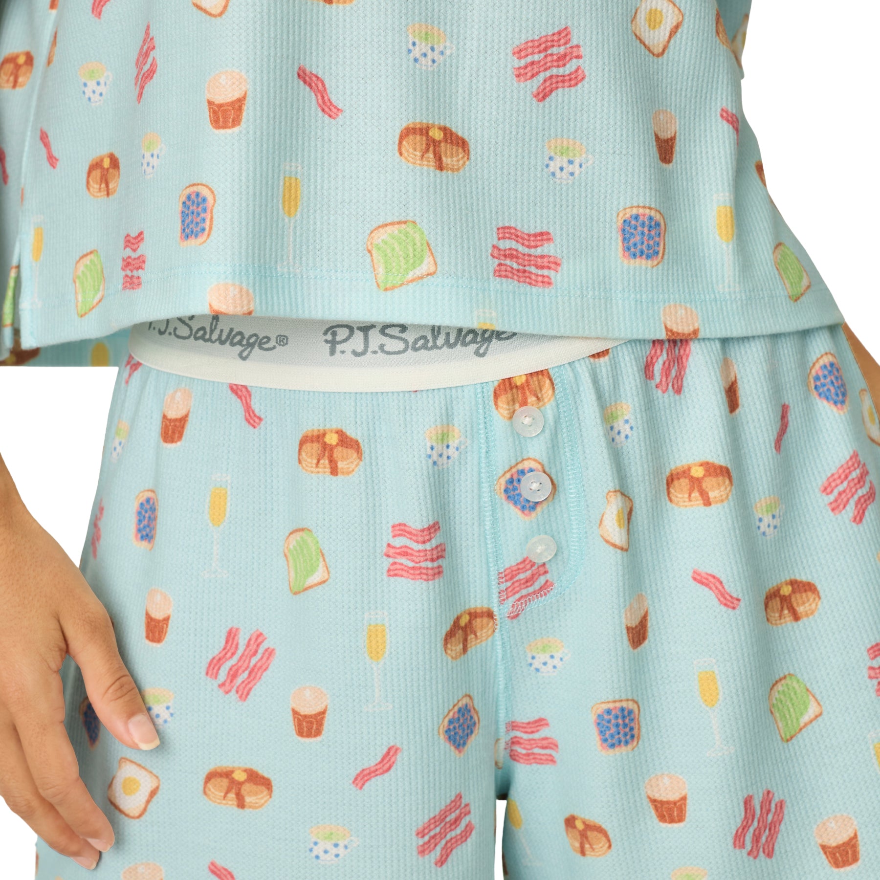 Detail of women's breakfast print pajama shorts with PJ Salvage logo waistband, decorative button fly, and soft waffle knit fabric.