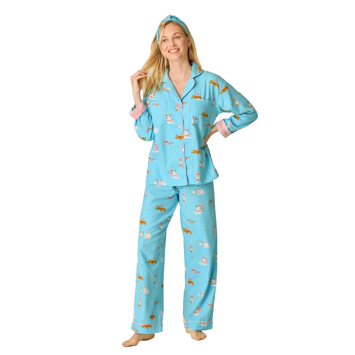 Model wearing PJ Salvage Paws & Relax flannel pyjama set in bright blue with playful cat print, pink cuffs and matching headband, front view.