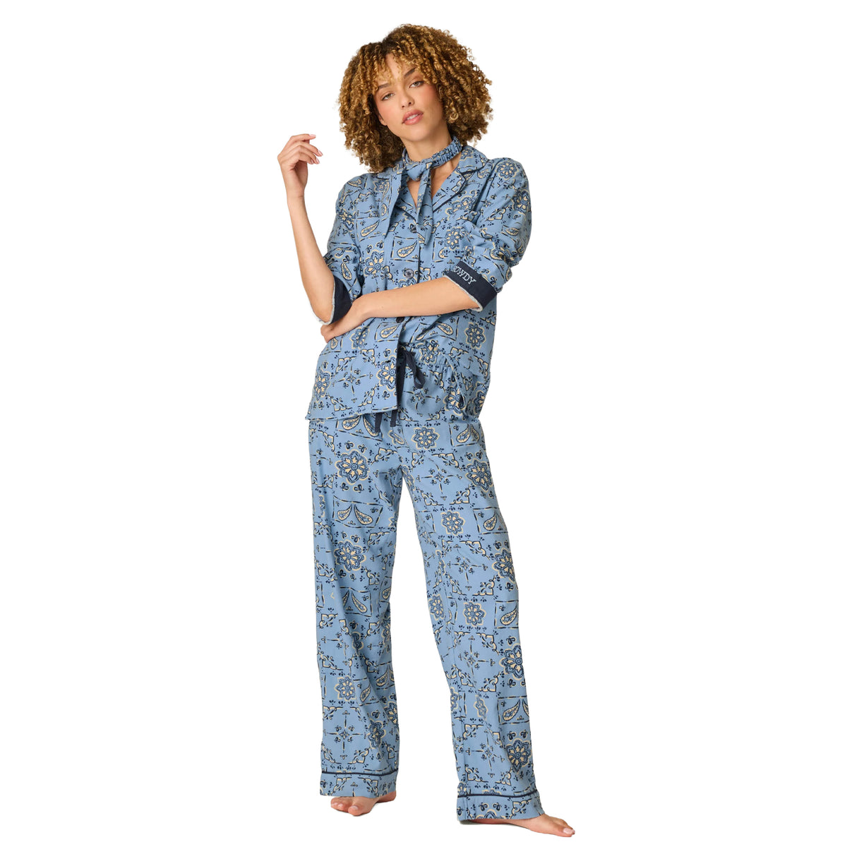 Model wearing PJ Salvage Howdy flannel pyjama set in Chambray Blue with navy and cream floral paisley print, front view.