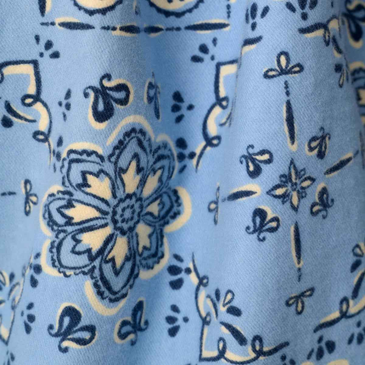 Close-up of PJ Salvage Howdy flannel fabric in Chambray Blue featuring intricate navy and cream floral paisley pattern.