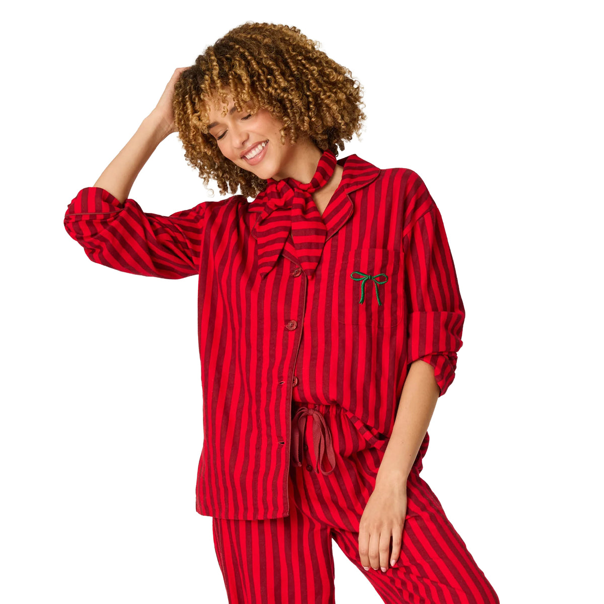 Model wearing red and burgundy striped flannel pajama set with matching neck scarf and drawstring pants, front view.