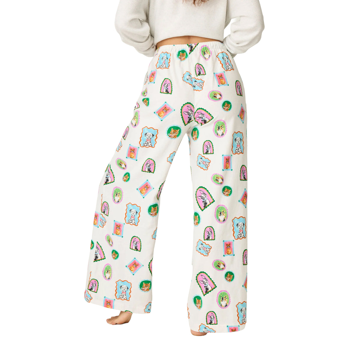 Back view of cream wide-leg pajama pants with an all-over colorful dog and cat portrait print and elastic waistband.