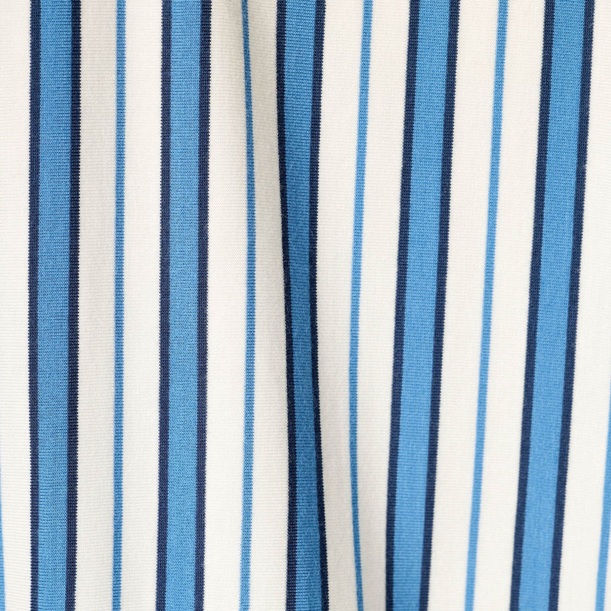Close-up of soft blue, navy and white striped fabric.
