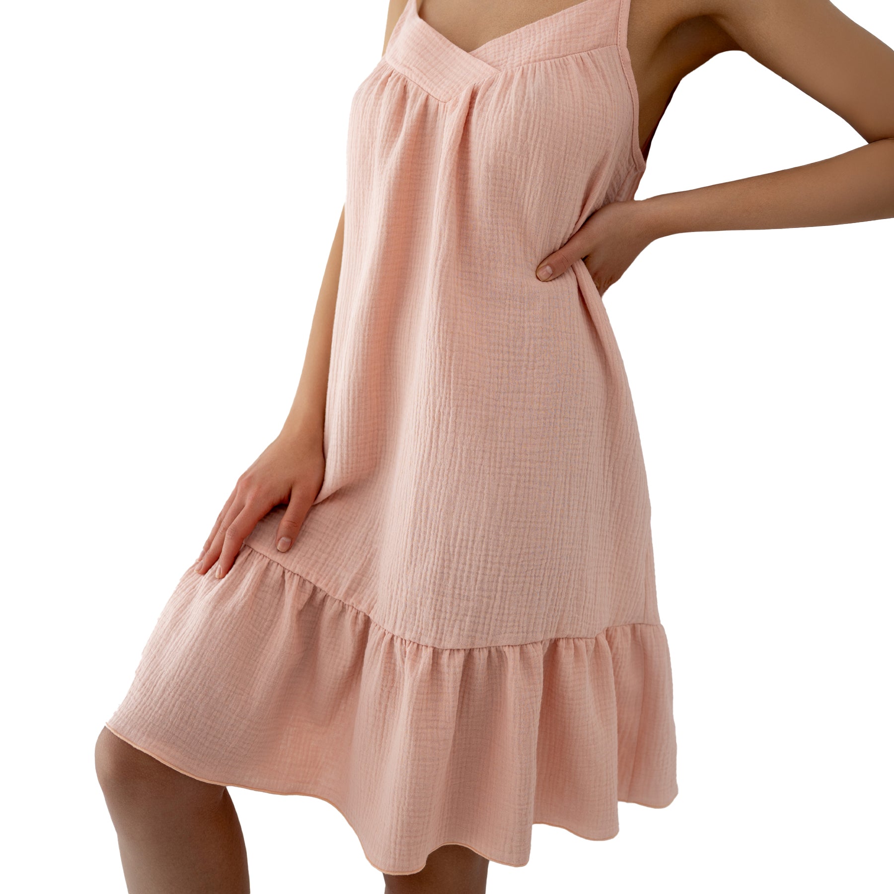 Close-up of blush pink sleep dress with delicate crinkle texture, gathered bust and tiered ruffle hem detail