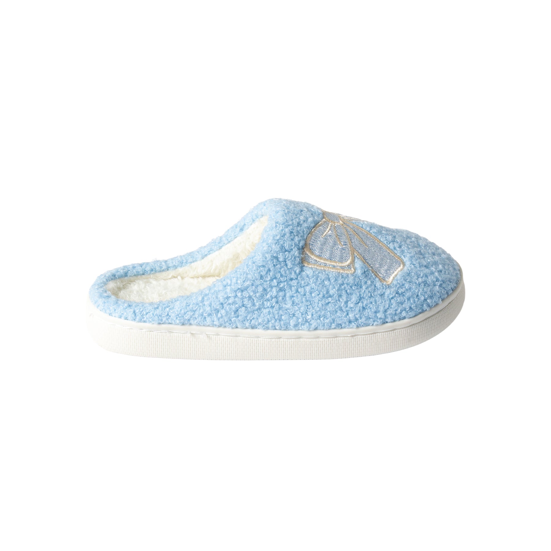Side view of a women's light blue sherpa mule slipper with an embroidered ivory bow, plush fleece lining, and cushioned white sole.