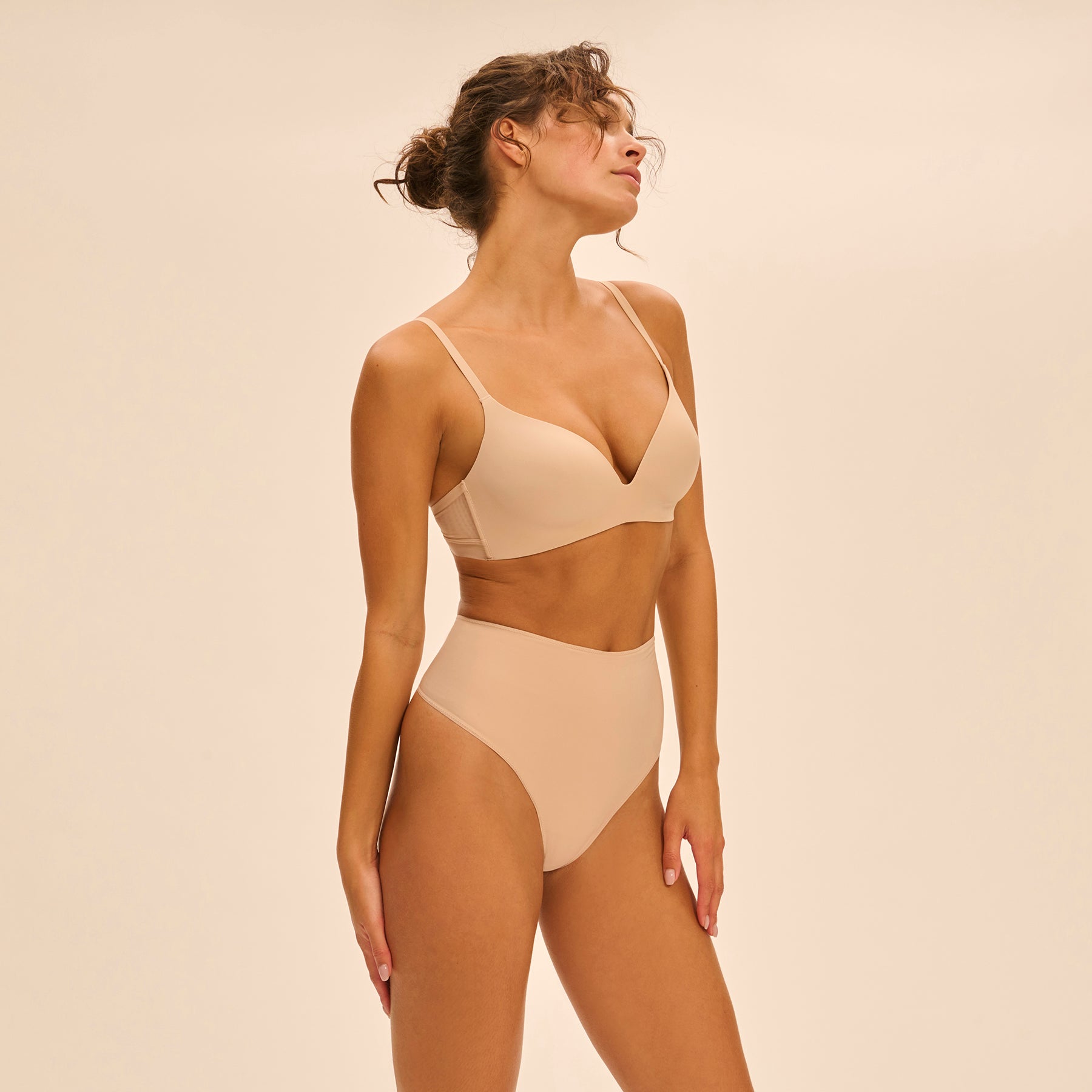 Side view of model in Peau Rosée wireless bra and matching Story Control thong, highlighting seamless finish and second-skin fit.