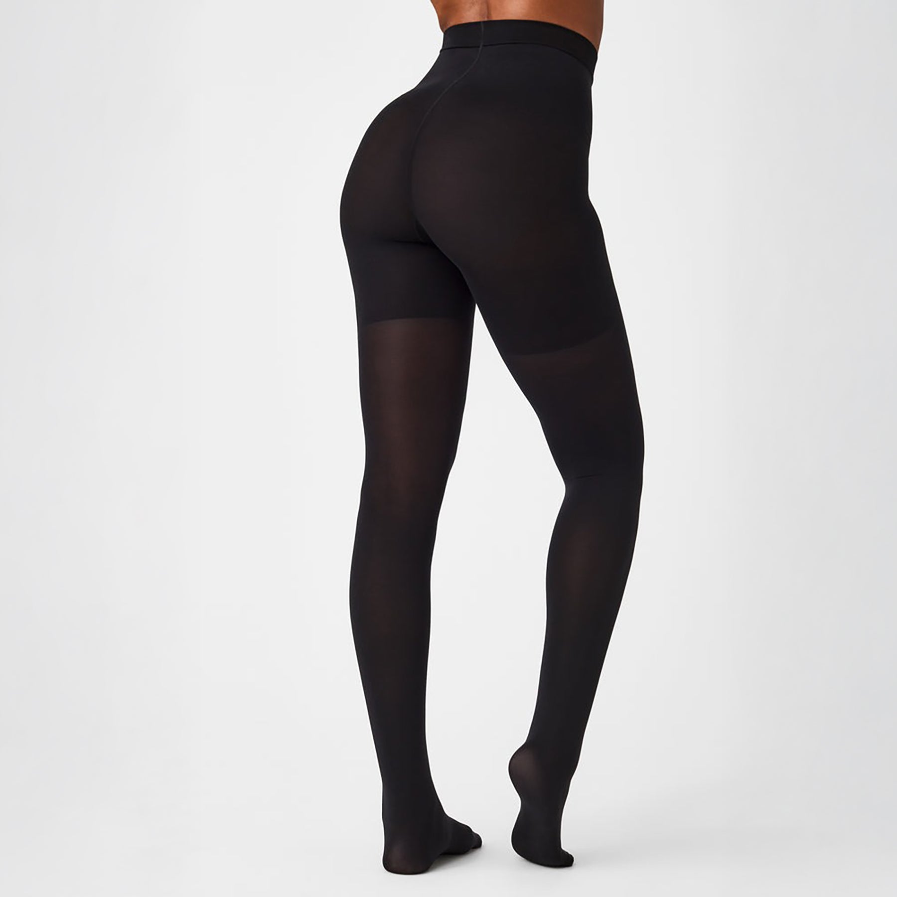 Back view of SPANX Mid-Thigh Control Tights in black, designed to lift and contour for a flattering silhouette.