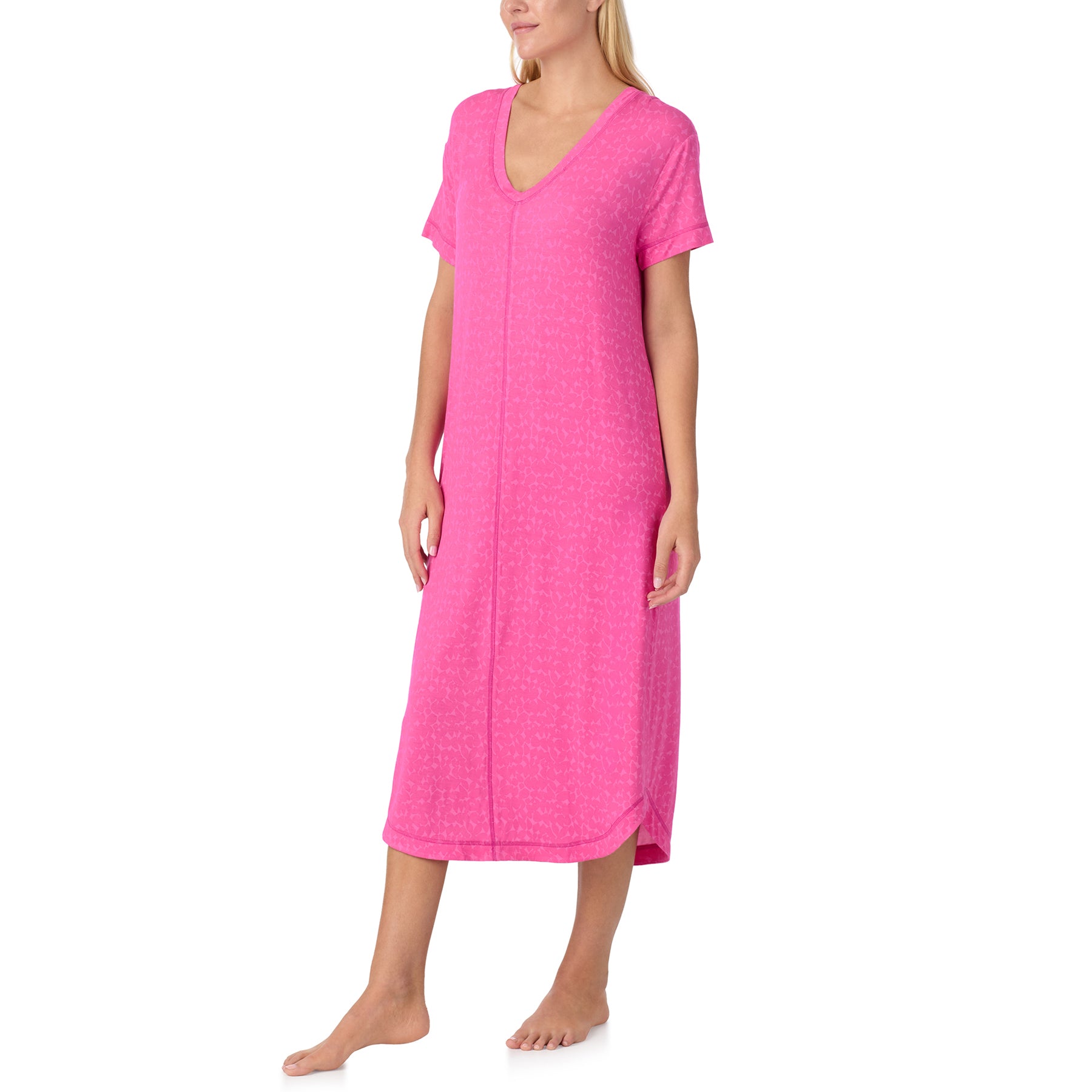 Woman wearing pink short sleeve nightgown with V-neckline, soft fabric and relaxed silhouette