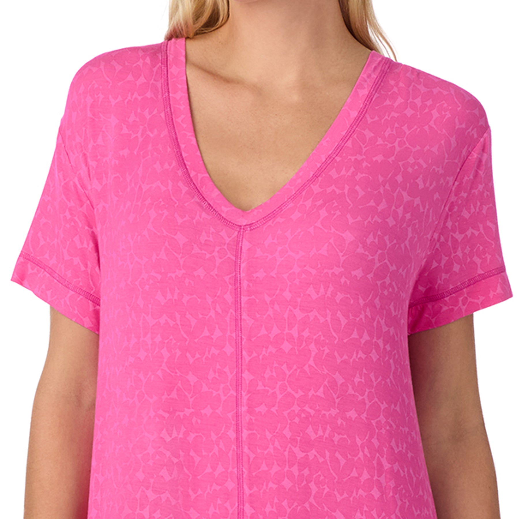 Close-up of pink nightgown with V-neckline, subtle tonal pattern and soft breathable fabric