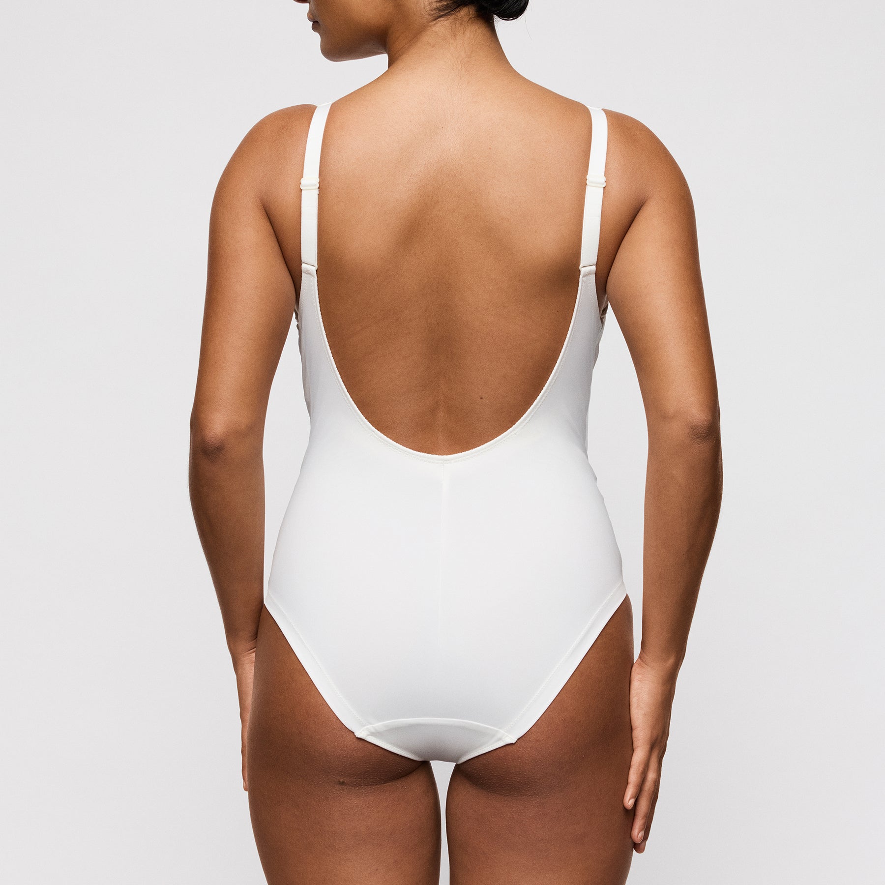 PrimaDonna Twist 0442532 Twixie bodysuit in natural ivory. Rear view on model showing low back.